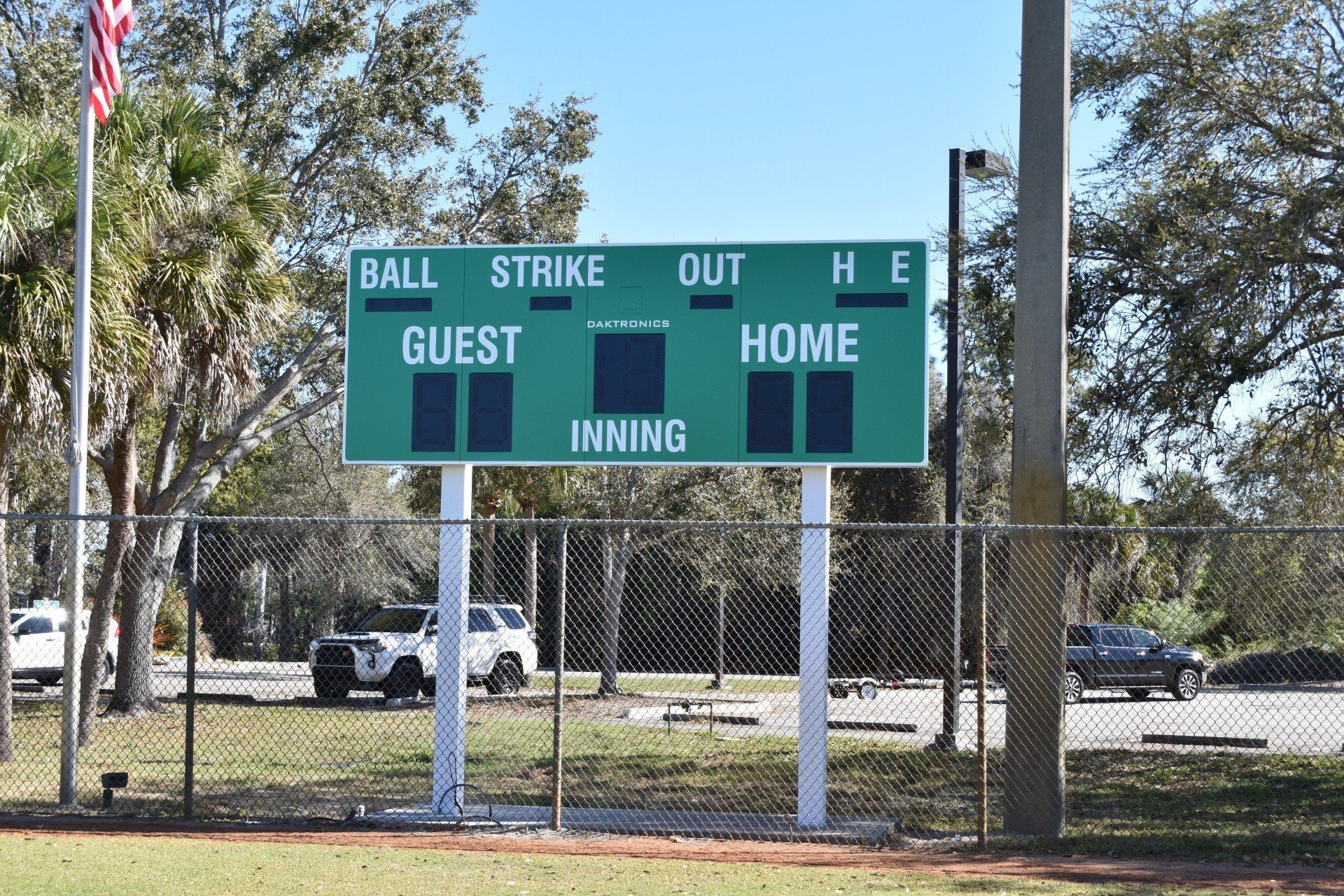 A baseball field with a scoreboard that says ball strike out guest home inning