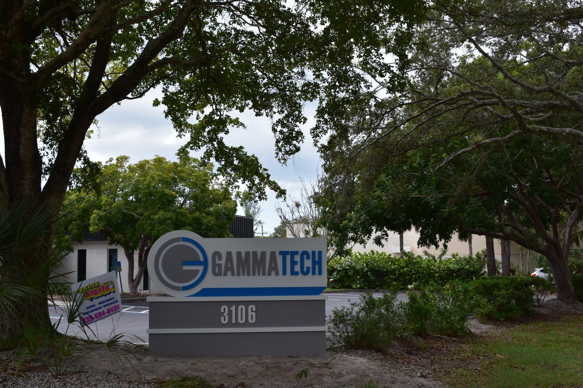 A sign for gammatech is in front of a building