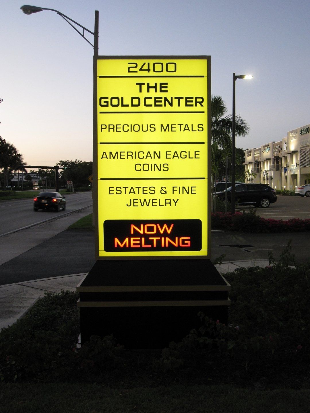 A sign that says 2400 the gold center precious metals american eagle coins estates & fine jewelry now melting