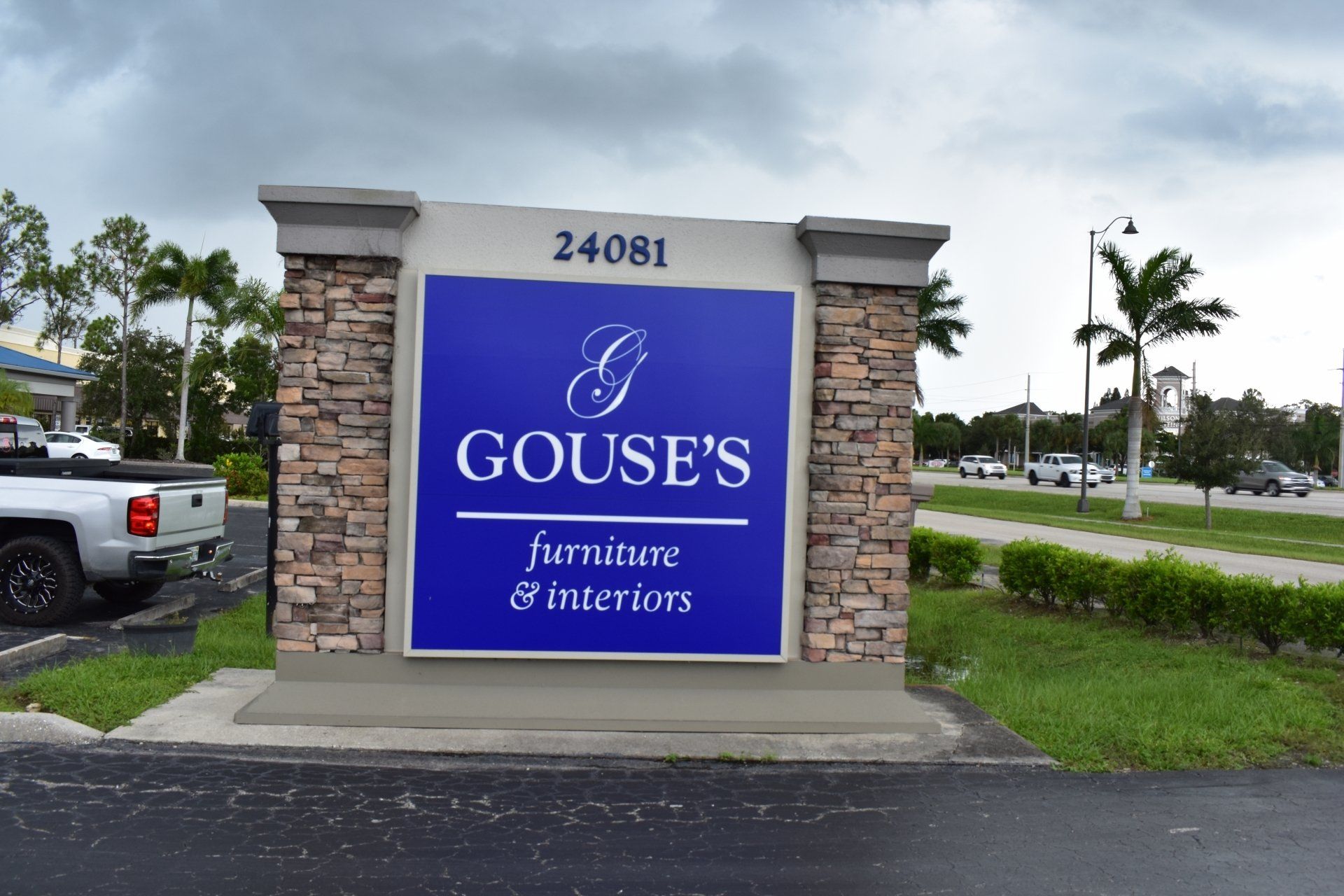 A blue sign for goose 's furniture and interiors