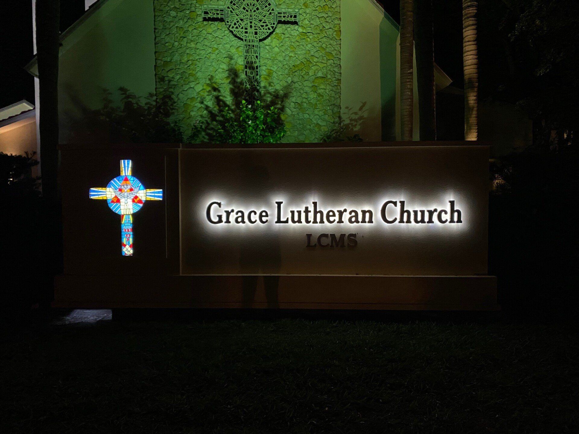 A sign for grace lutheran church is lit up at night