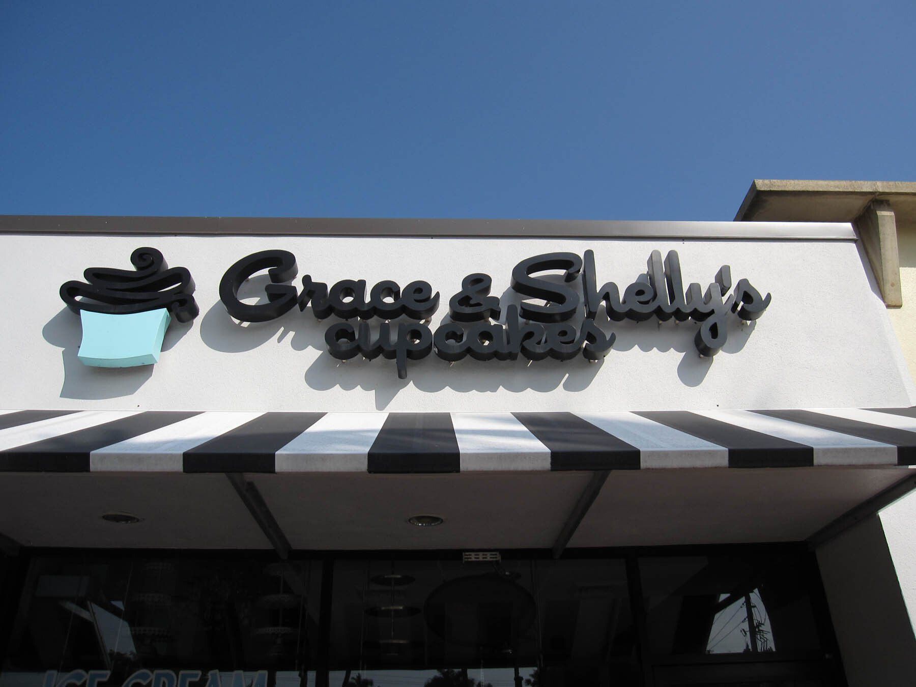 Grace and shelly 's cupcakes has a black and white awning
