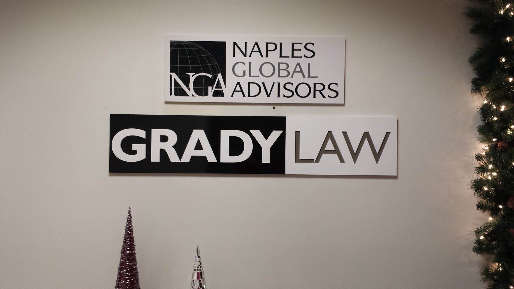 A sign on a wall that says naples global advisors and grady law