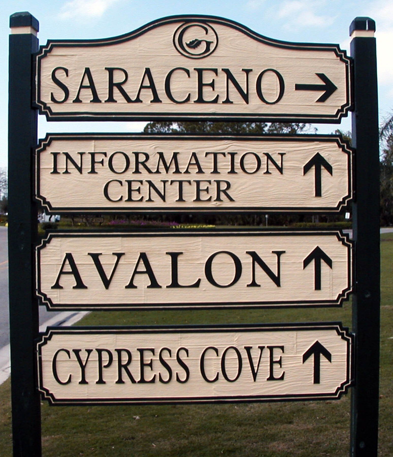 A sign pointing to saraceno information center avalon and cypress cove
