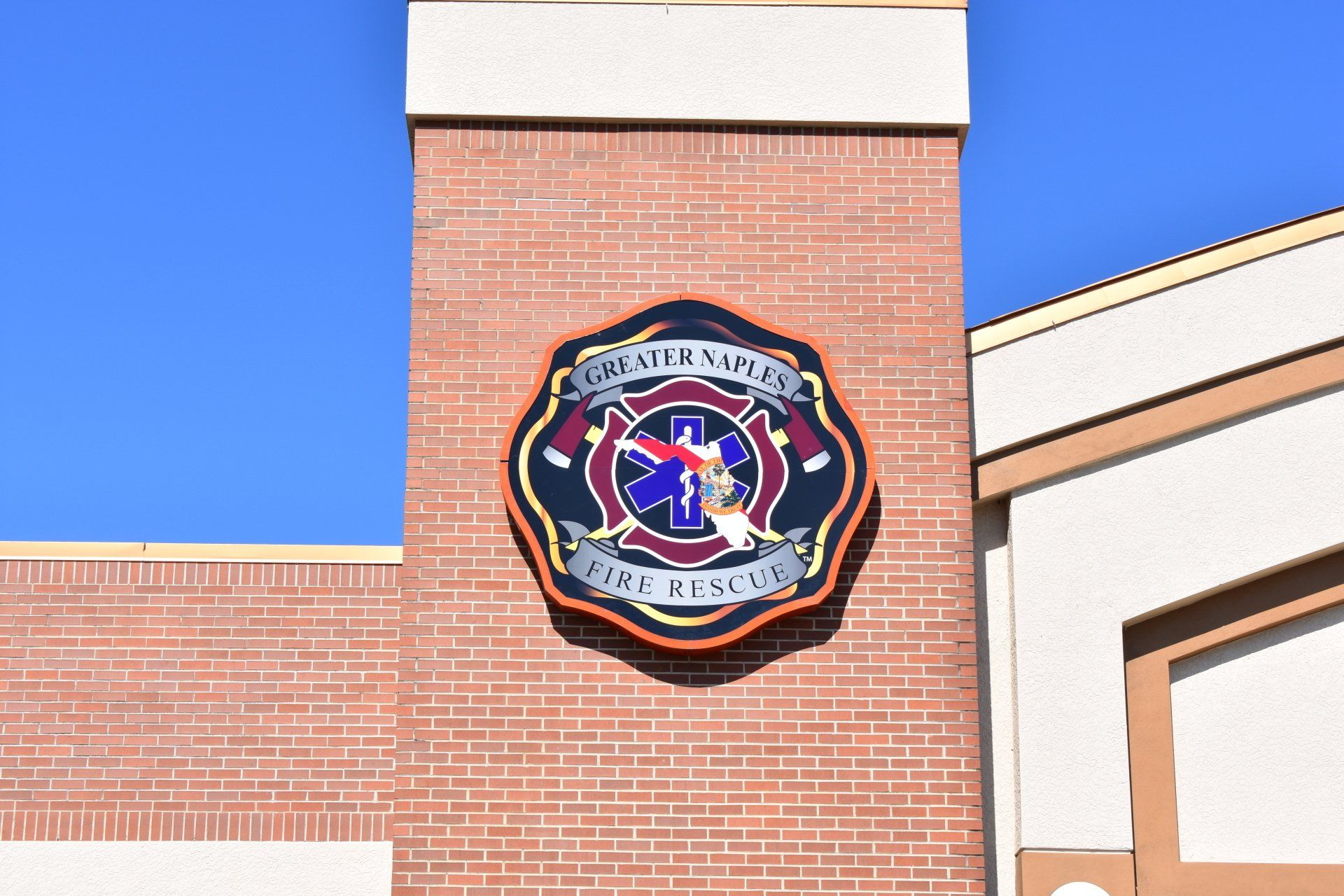 A brick building with a fire department logo on it