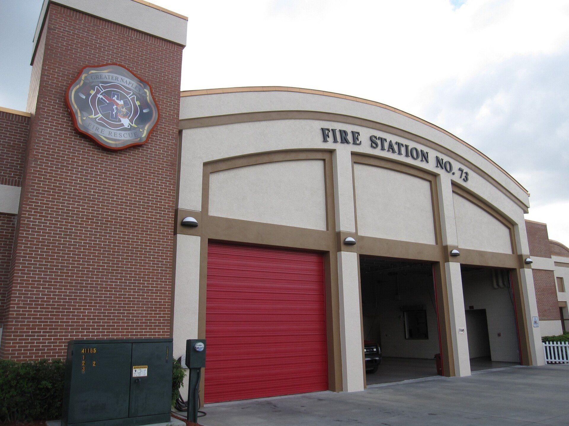 A fire station with a red garage door