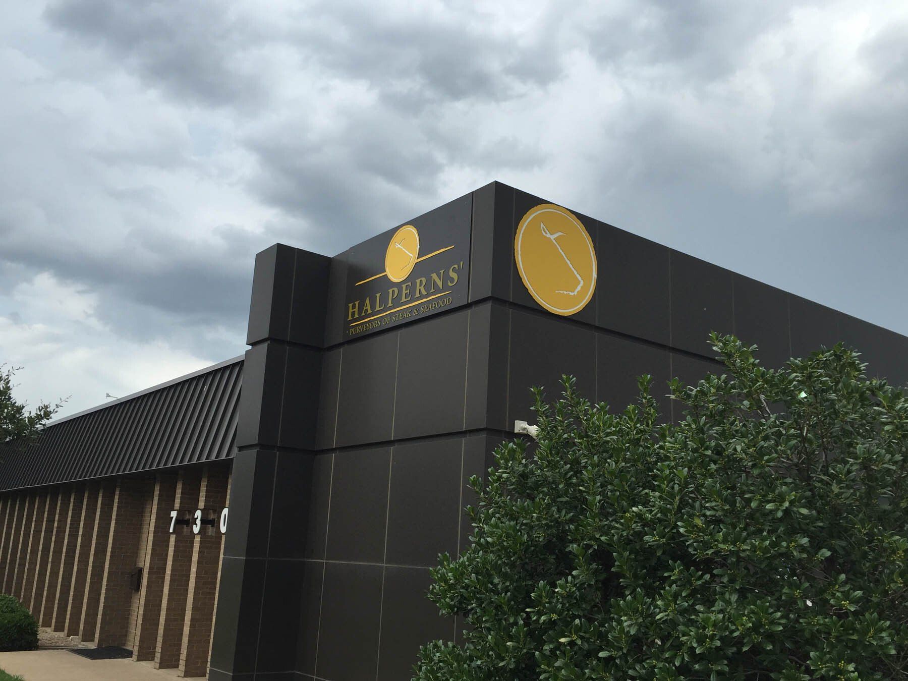 A large black building with a yellow circle on the side