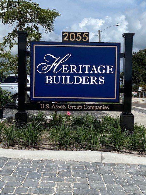A blue sign that says heritage builders on it