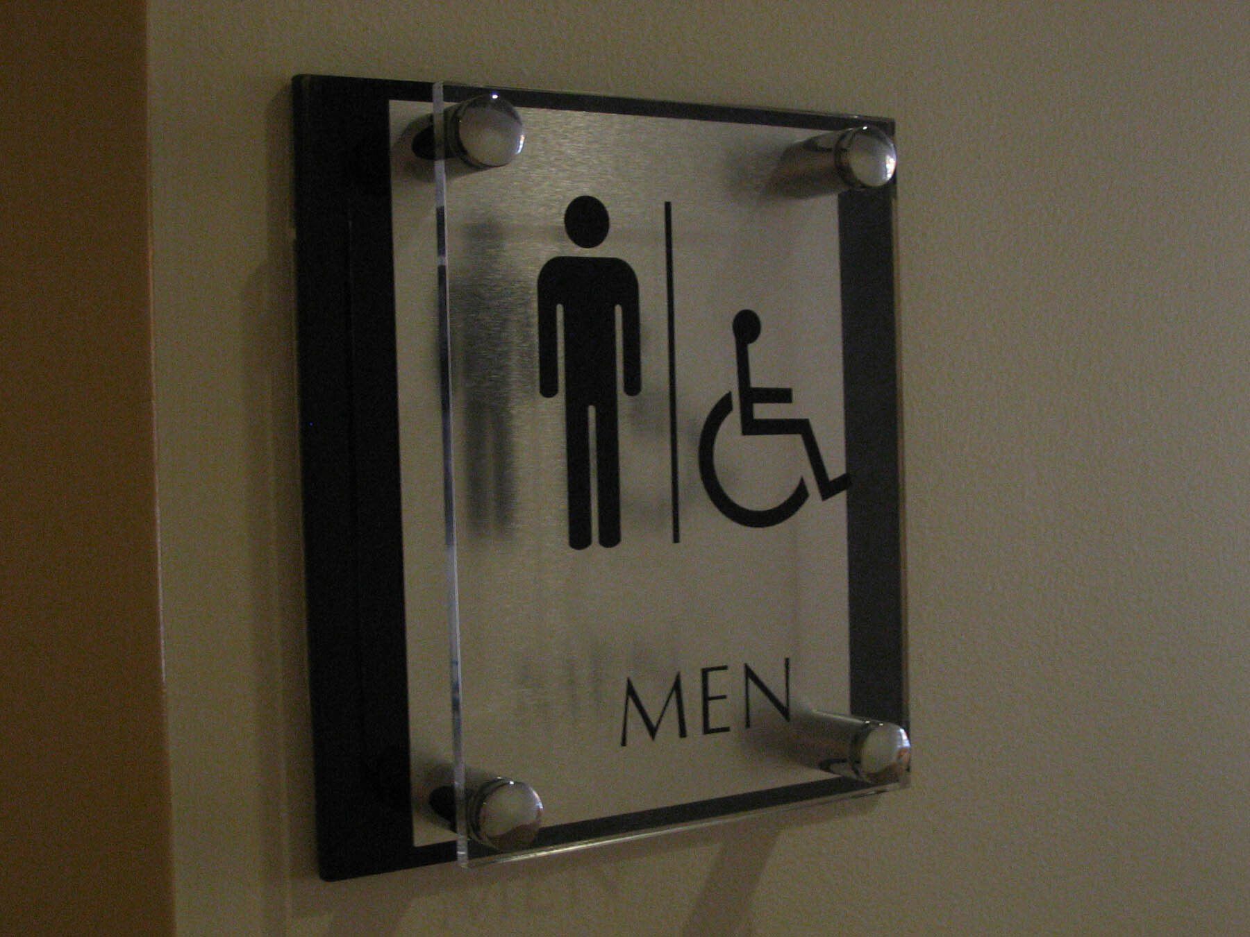 A sign for a men 's bathroom with a handicapped symbol