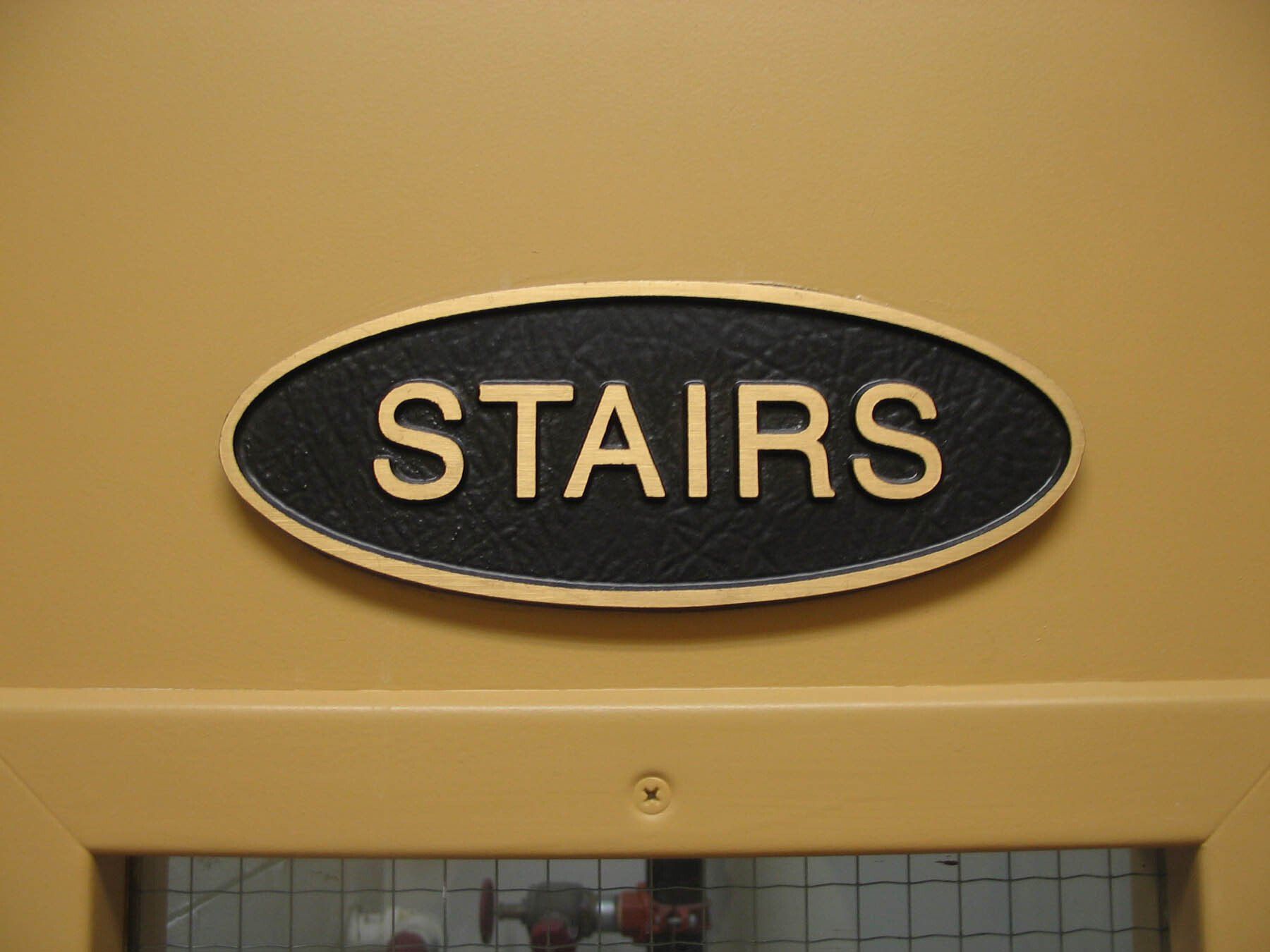 A sign on a door that says stairs on it