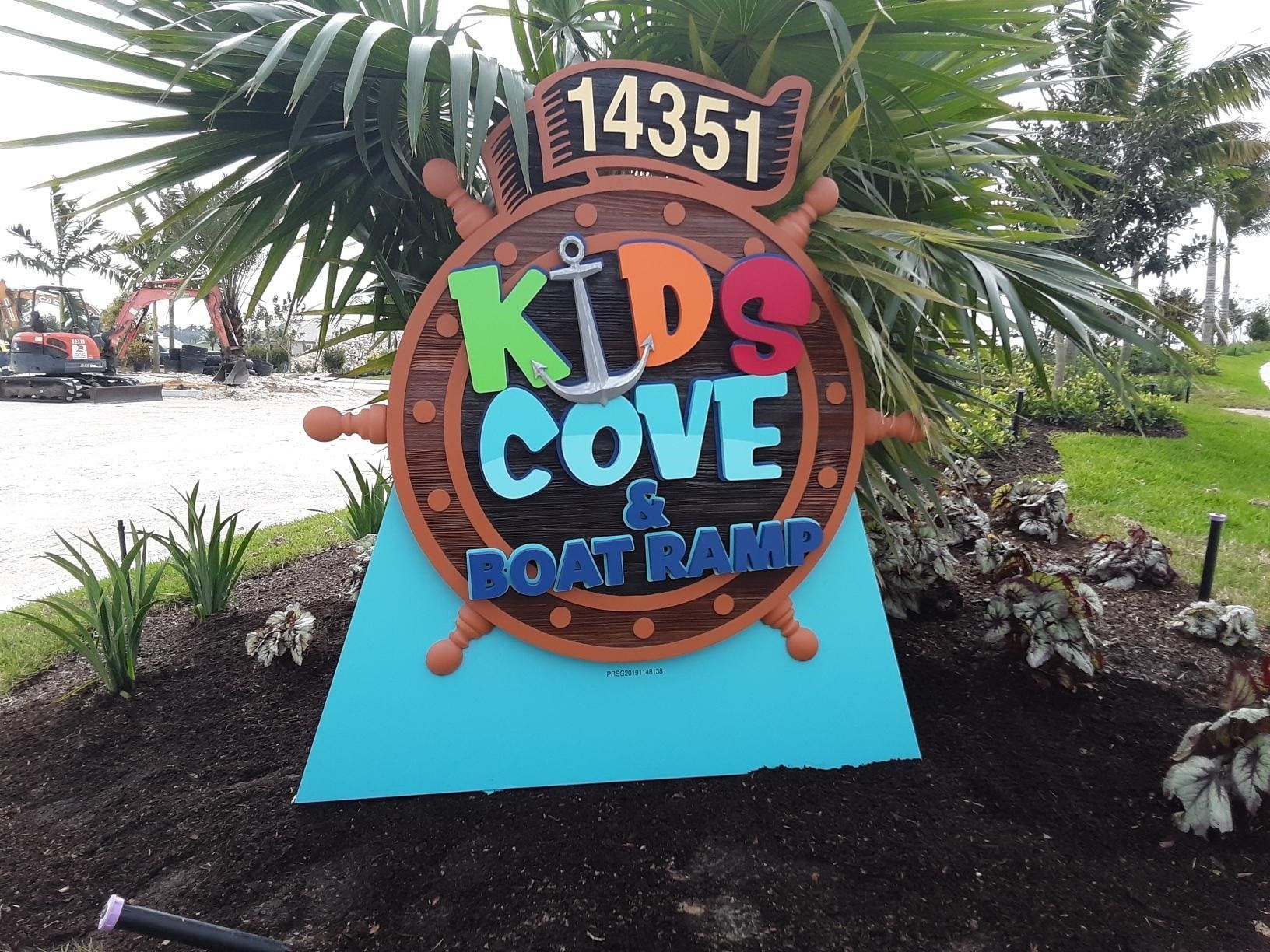 A sign that says kids cove and boat ramp