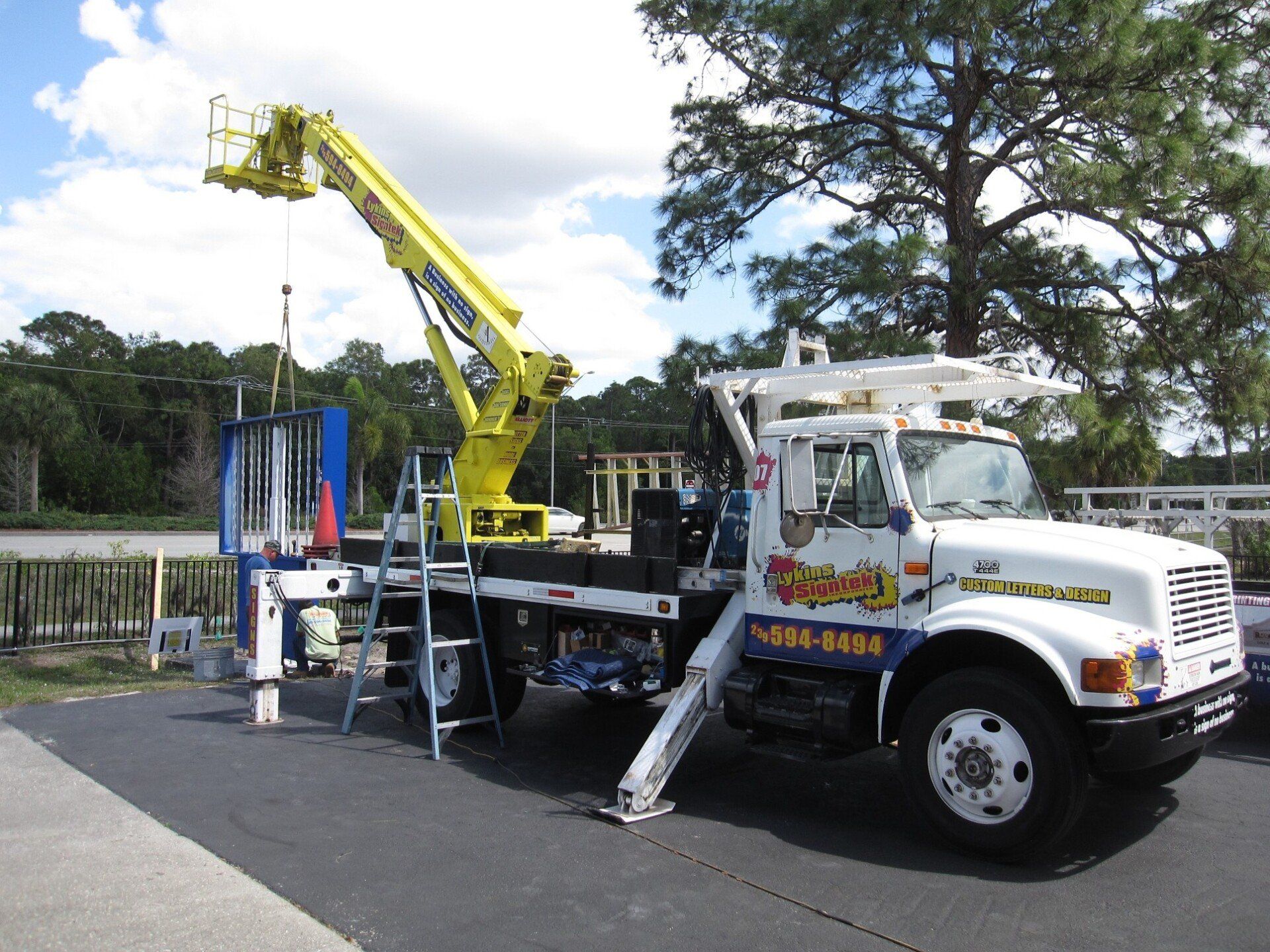 A tow truck with a crane on the back of it