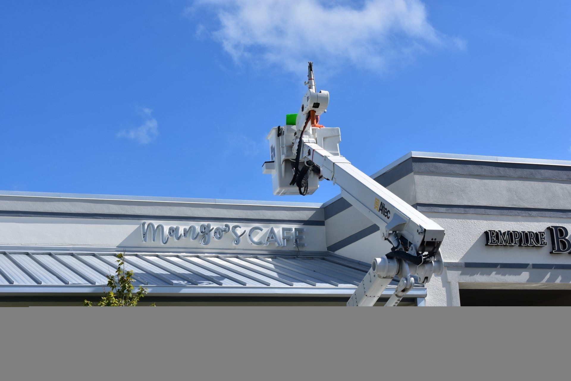 A man is working on the side of a building.