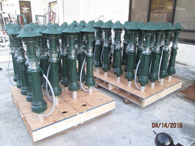 A bunch of green poles are sitting on a wooden pallet