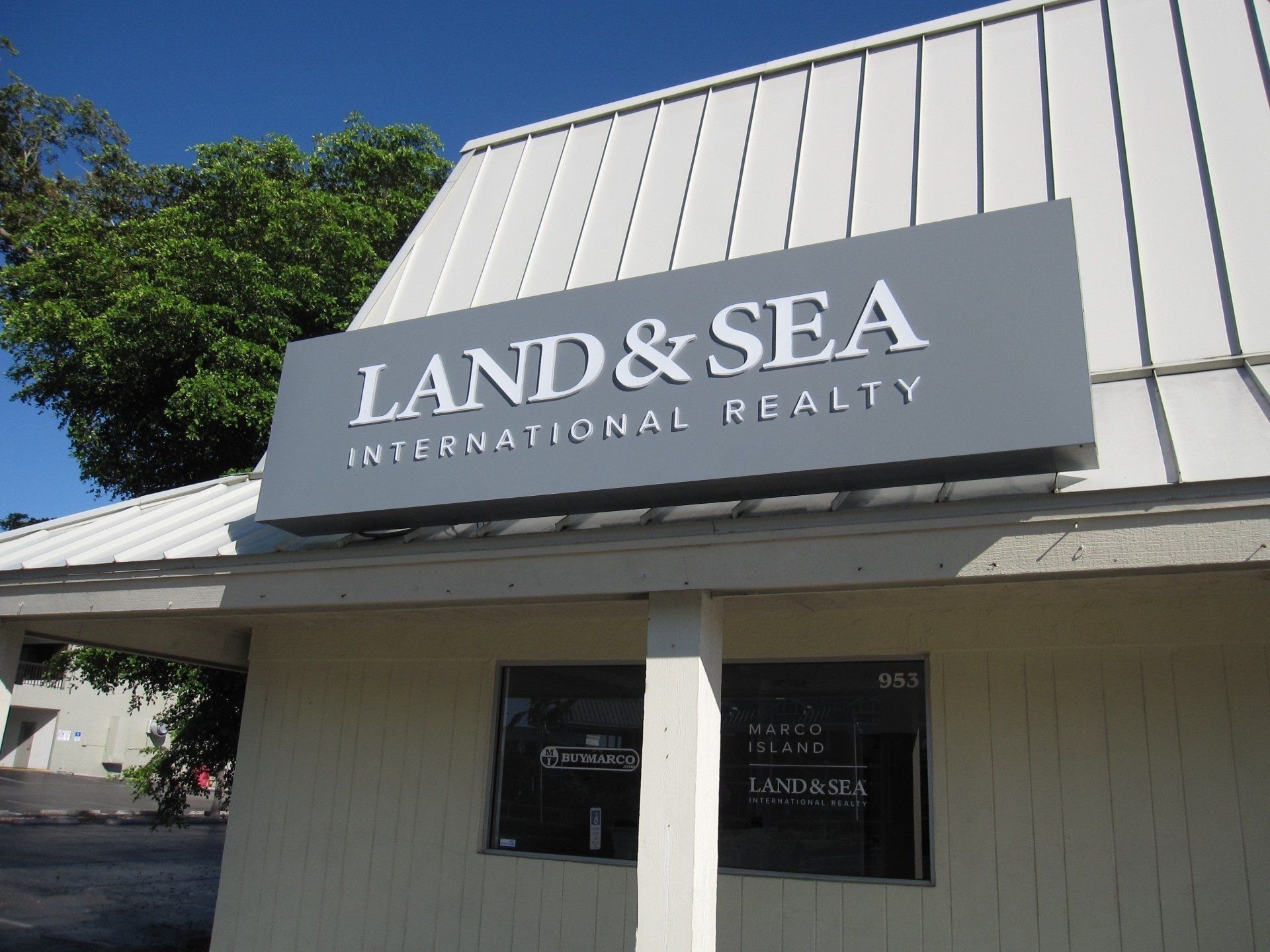 A building with a sign that says land & sea international realty