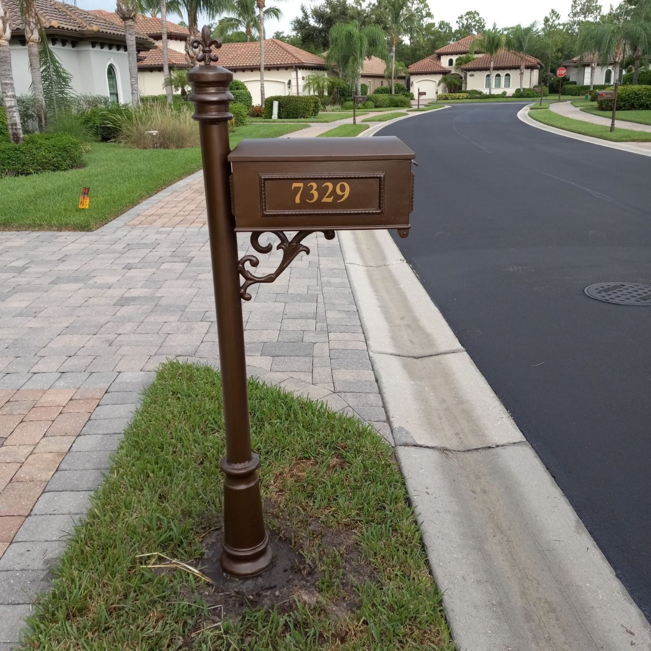 A brown mailbox with the address 7329 on it