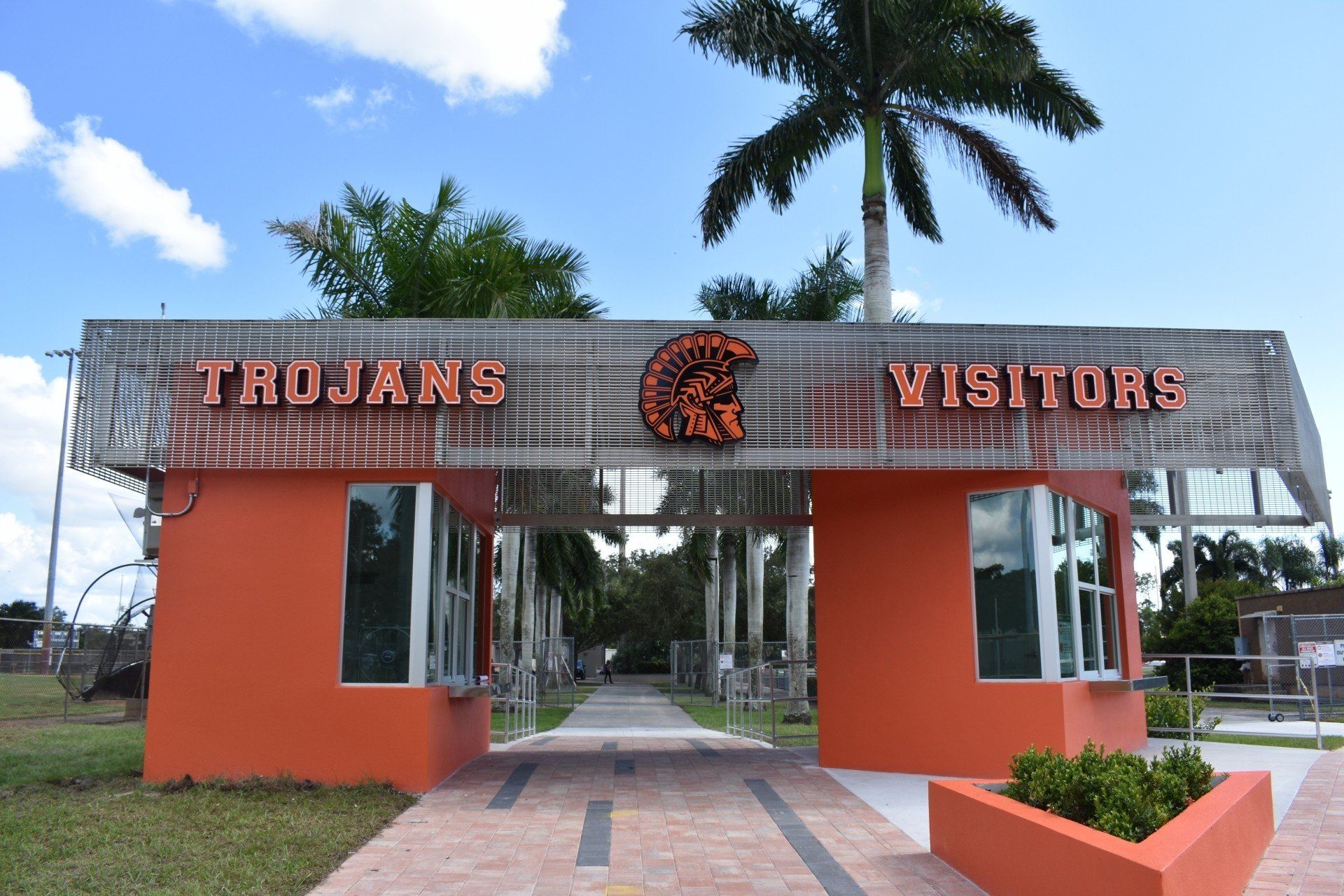 An orange building with a sign that says trojans visitors