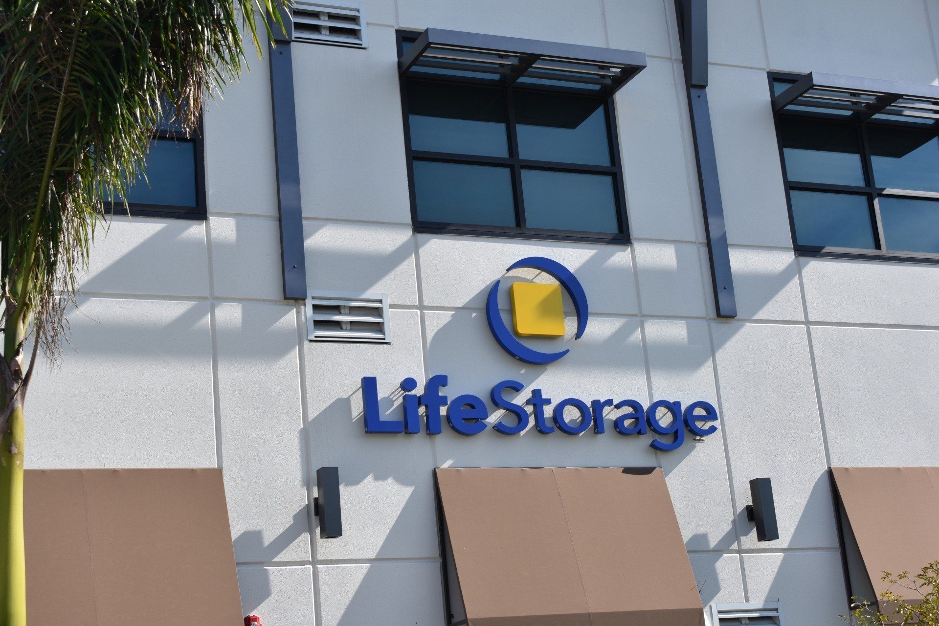A building with a blue sign that says life storage