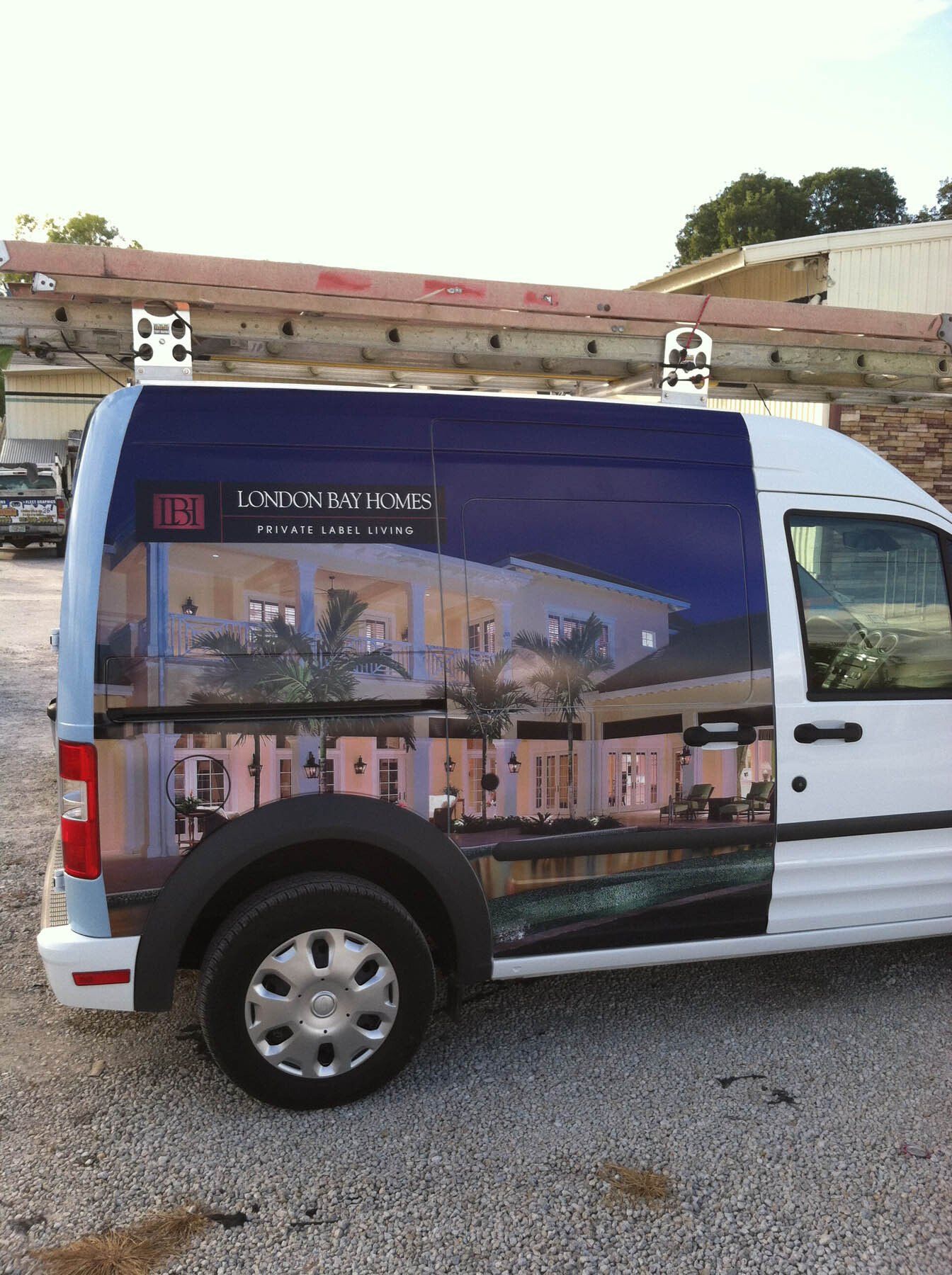 A white van with a picture of a building on the side