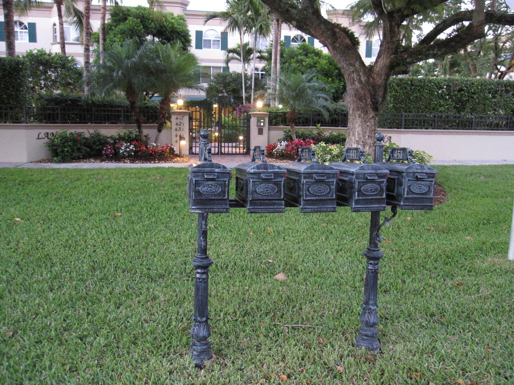 A row of mailboxes in a lush green field