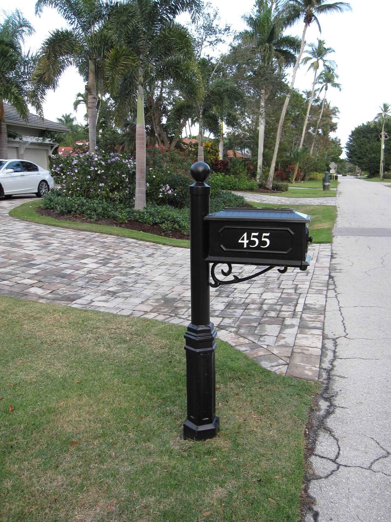 A black mailbox with the number 455 on it