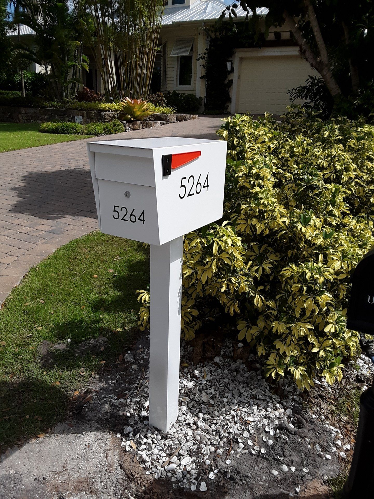 A white mailbox with the number 5264 on it