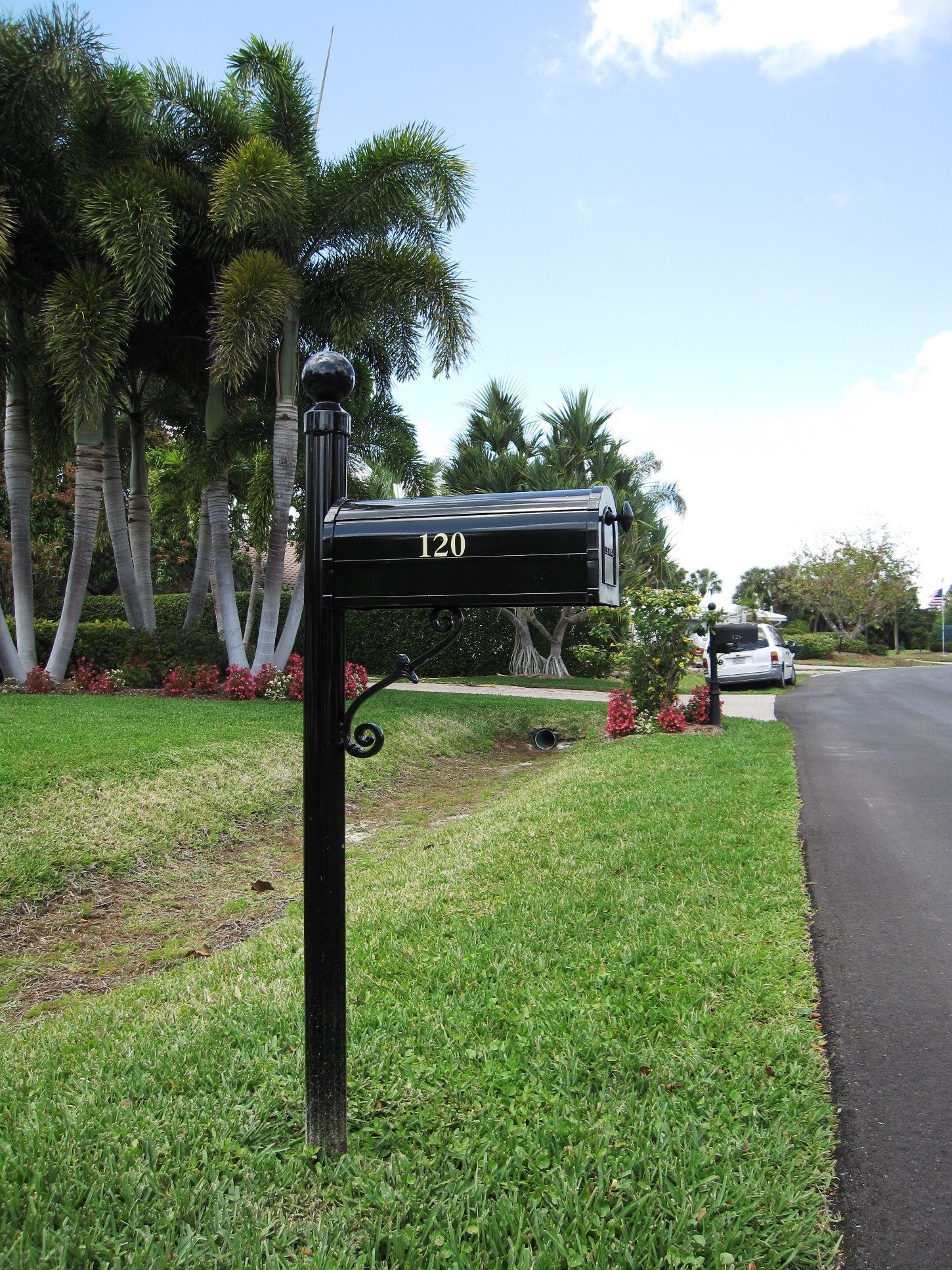 A black mailbox with the number 120 on it