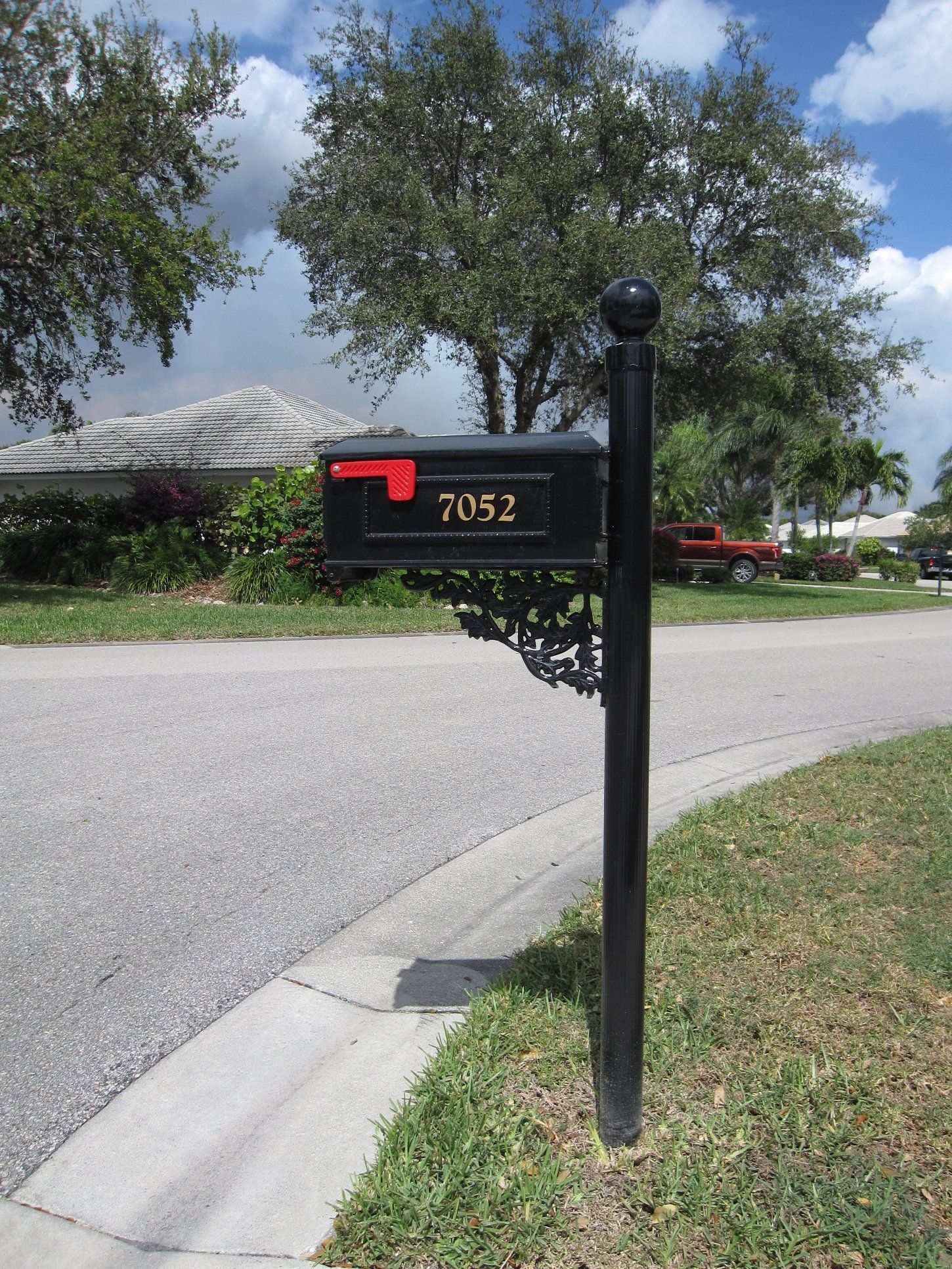 A black mailbox with the number 2052 on it