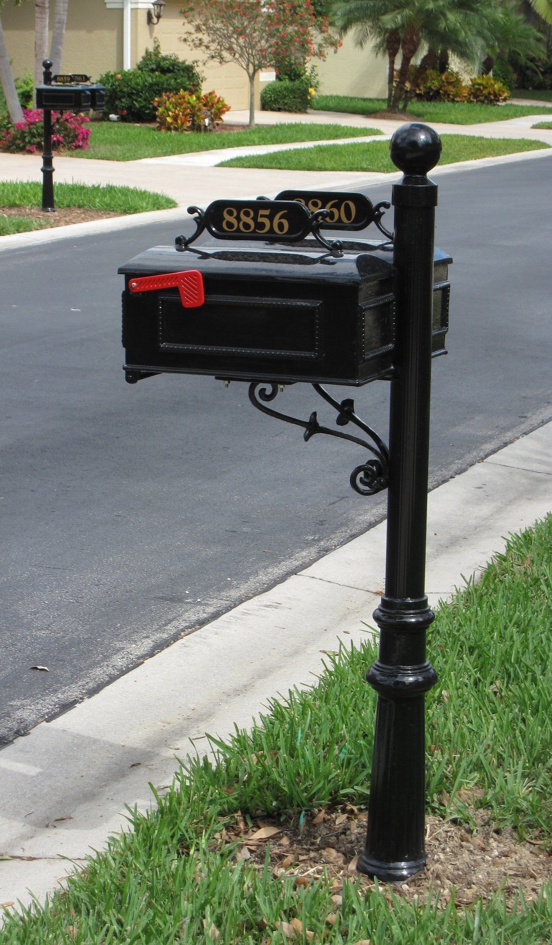 A black mailbox with the address h956 on it