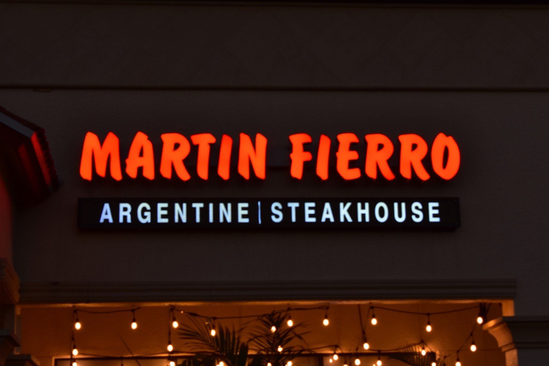 Martin fierro argentina steakhouse is lit up at night