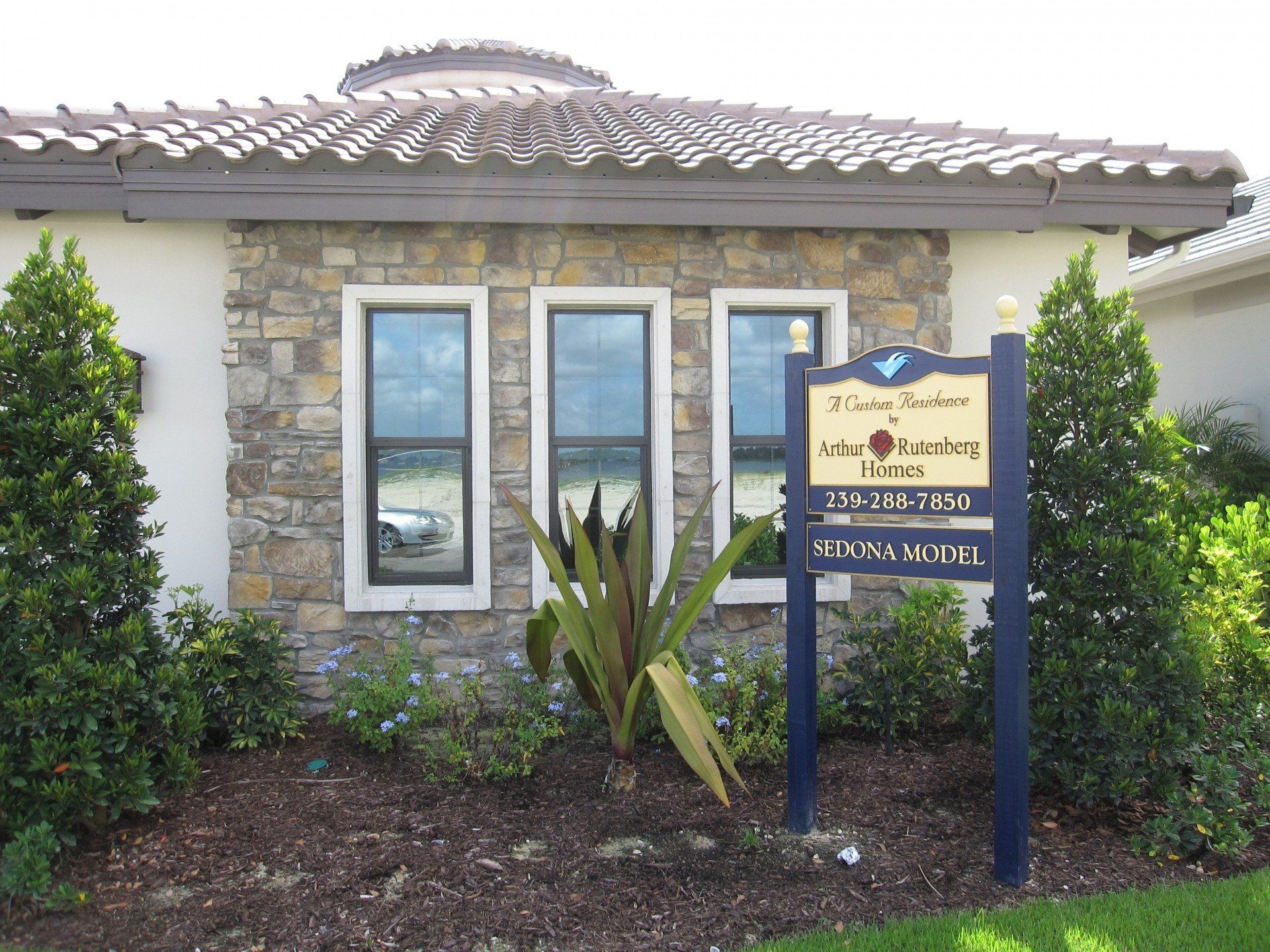 A house with a blue sign in front of it