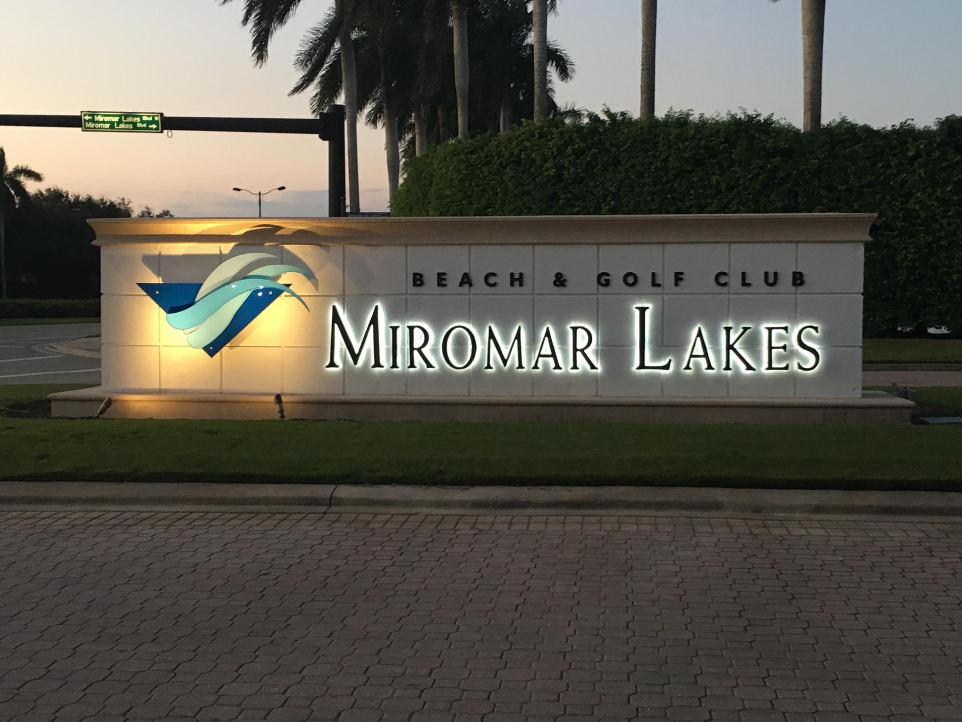 A sign for the miromar lakes beach and golf club