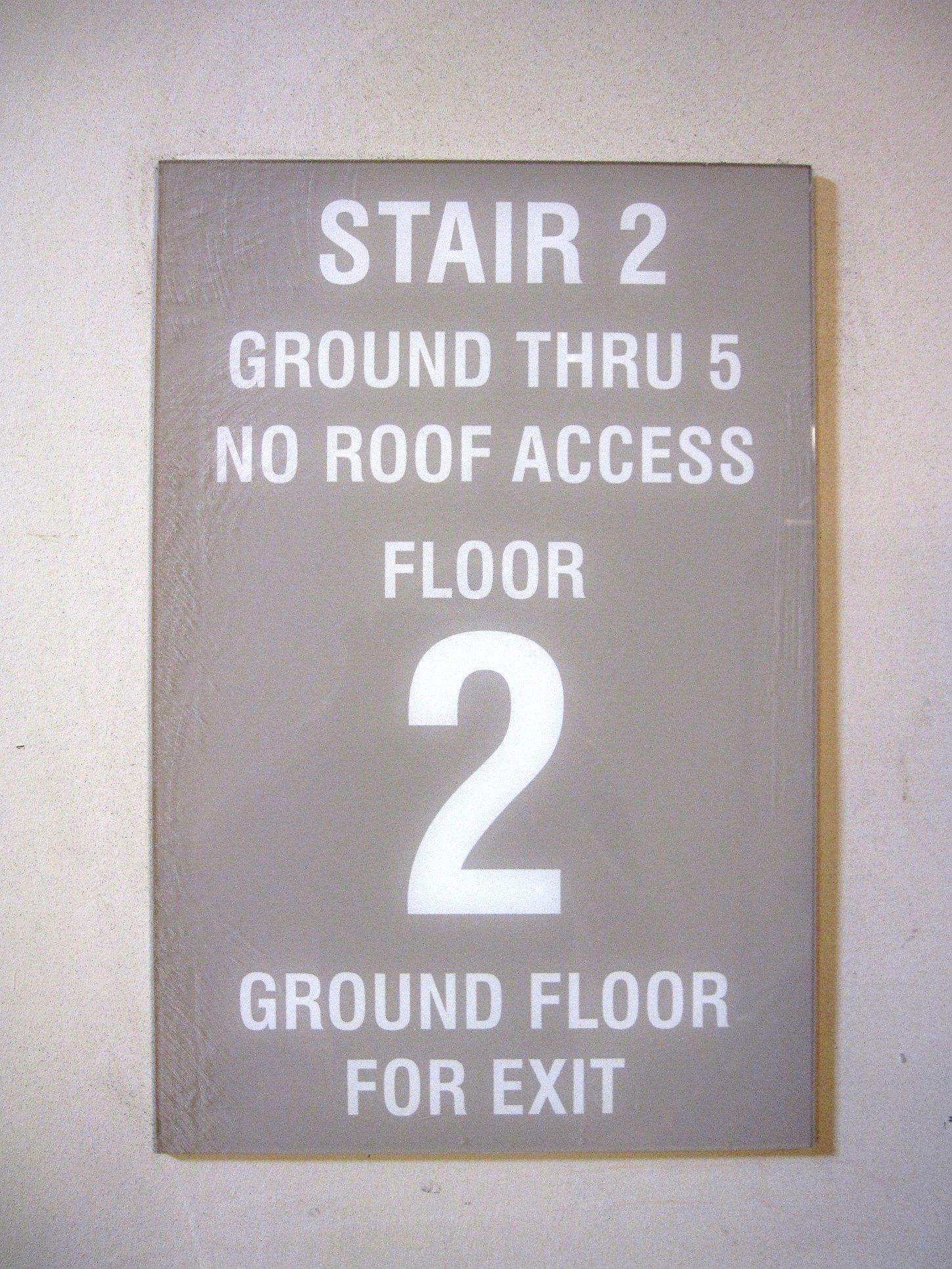 A sign that says stair 2 ground thru 5 no roof access floor 2 ground floor for exit