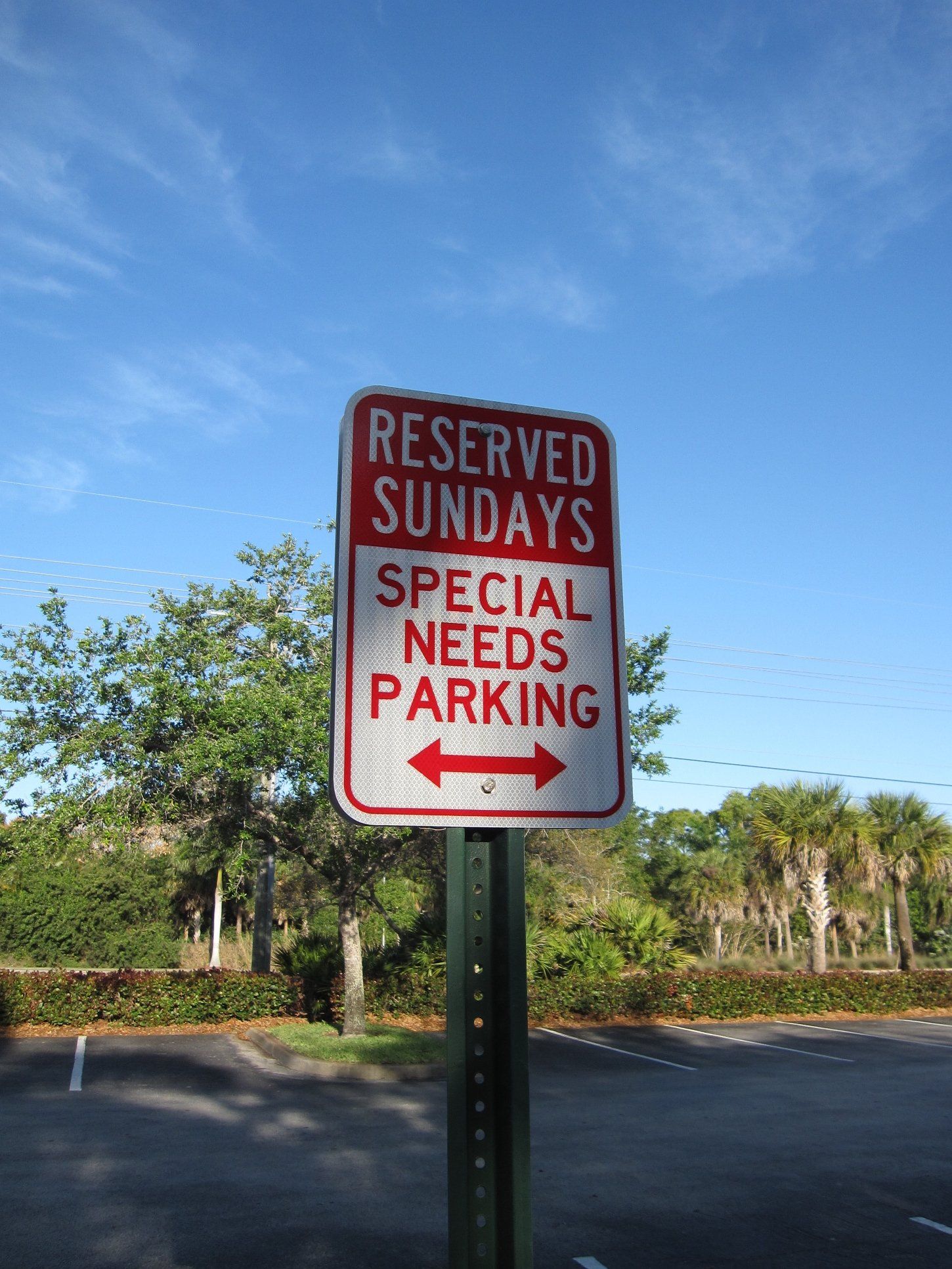 A sign that says reserved sundays special needs parking
