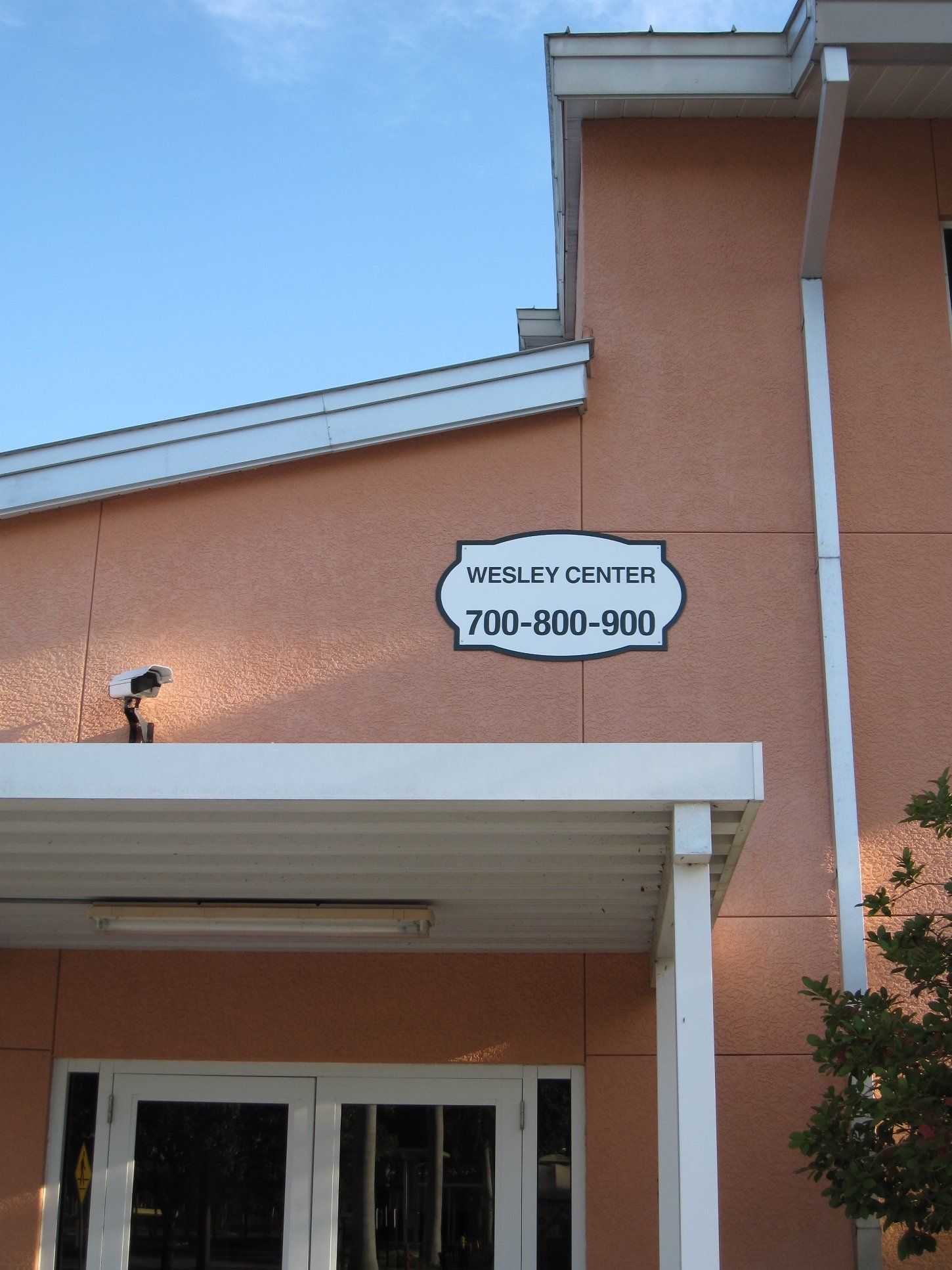A sign on the side of a building says wesley center