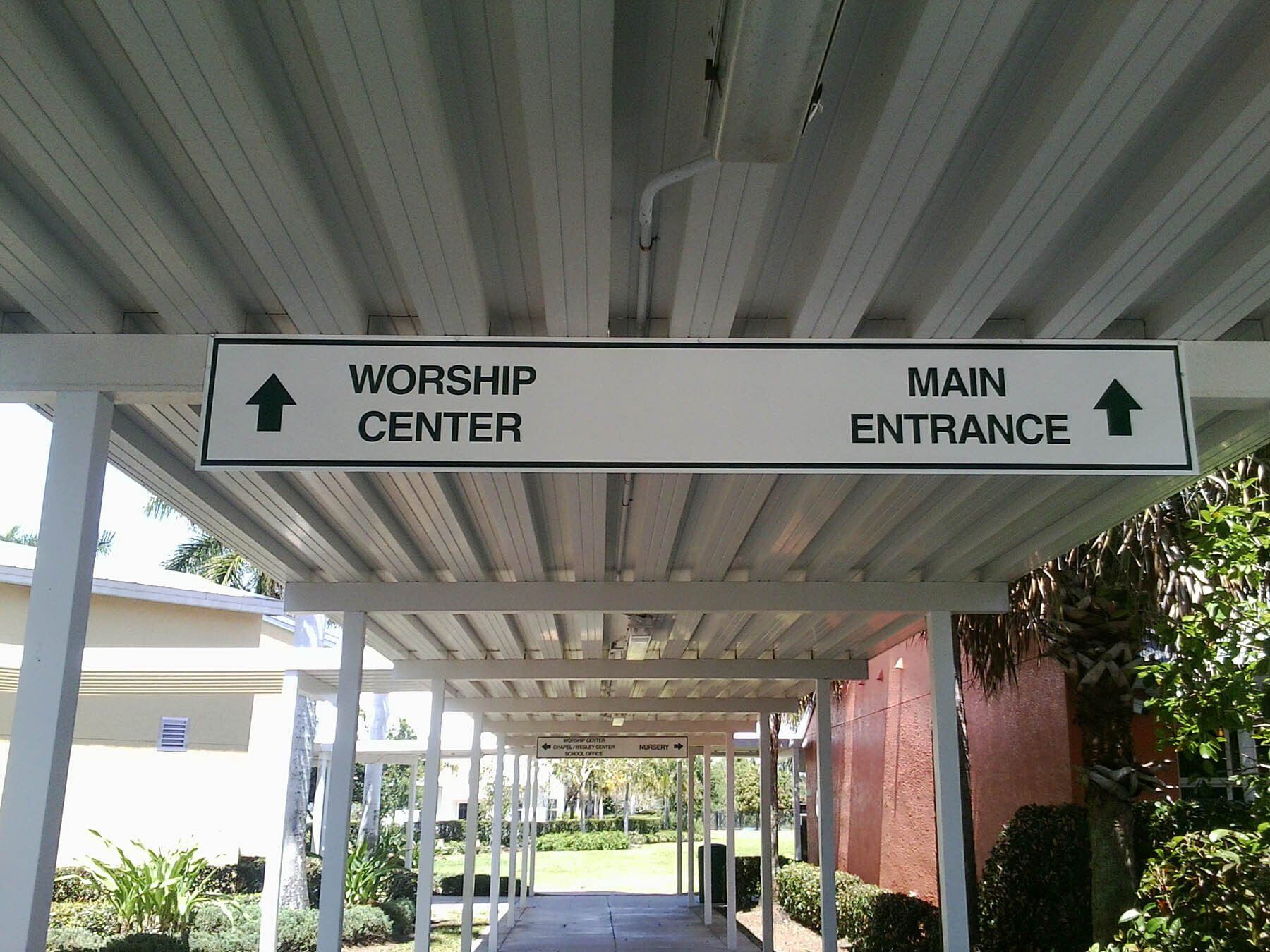 A sign shows the way to the worship center and the main entrance