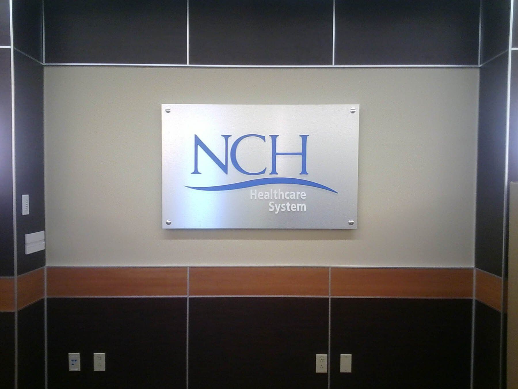 A sign for nch healthcare system hangs on a wall