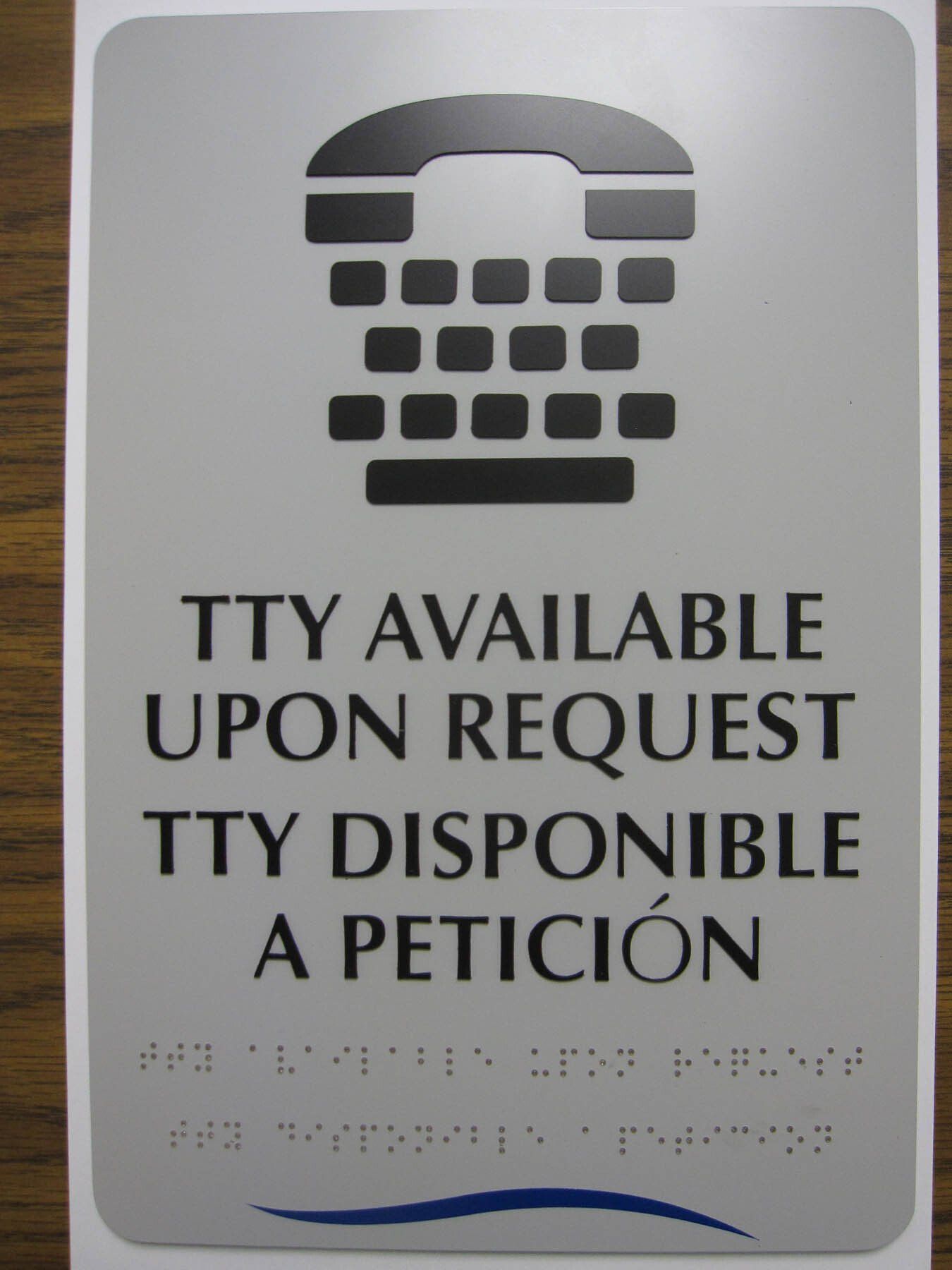 A sign that says tty available upon request
