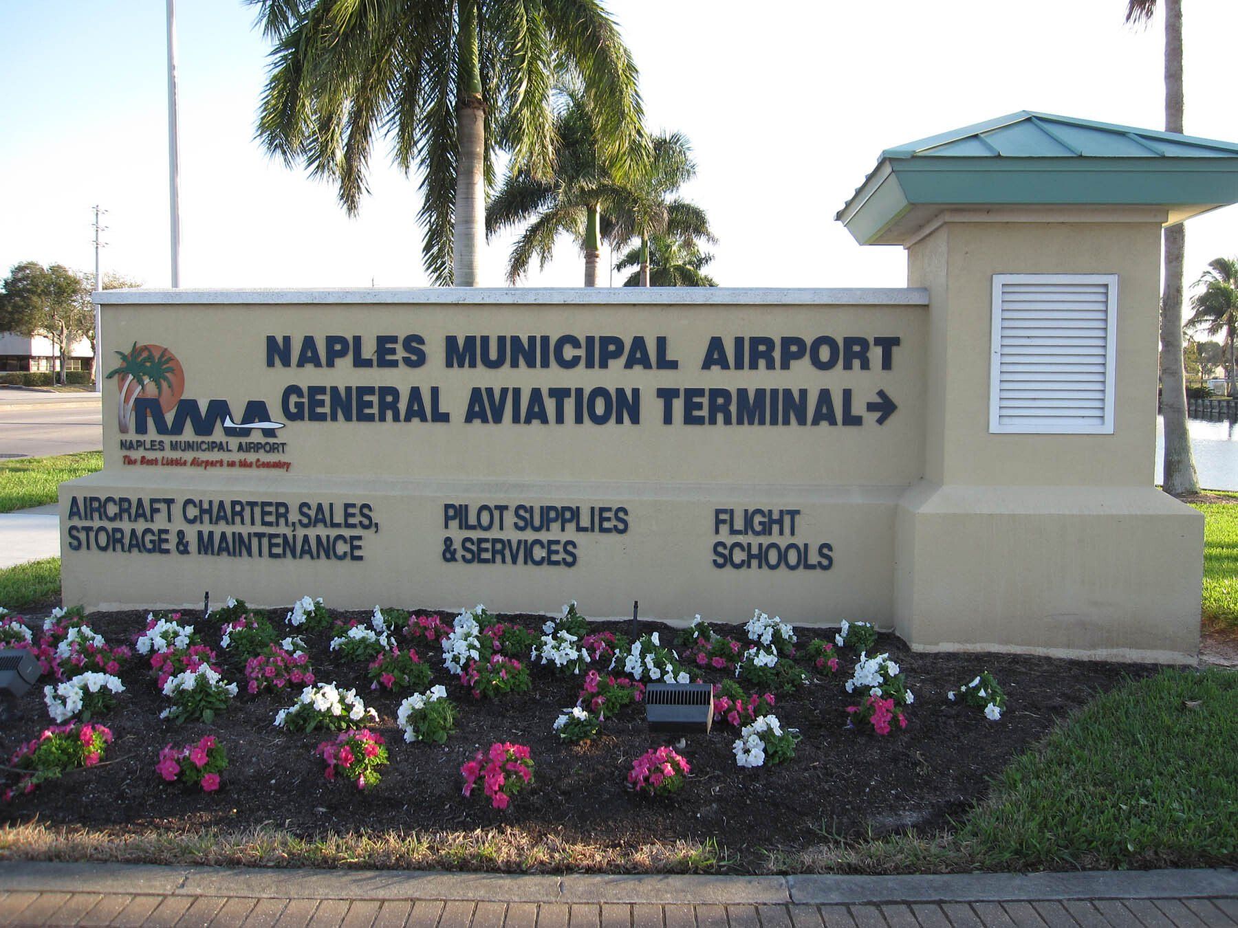 A sign for the naples municipal airport general aviation terminal