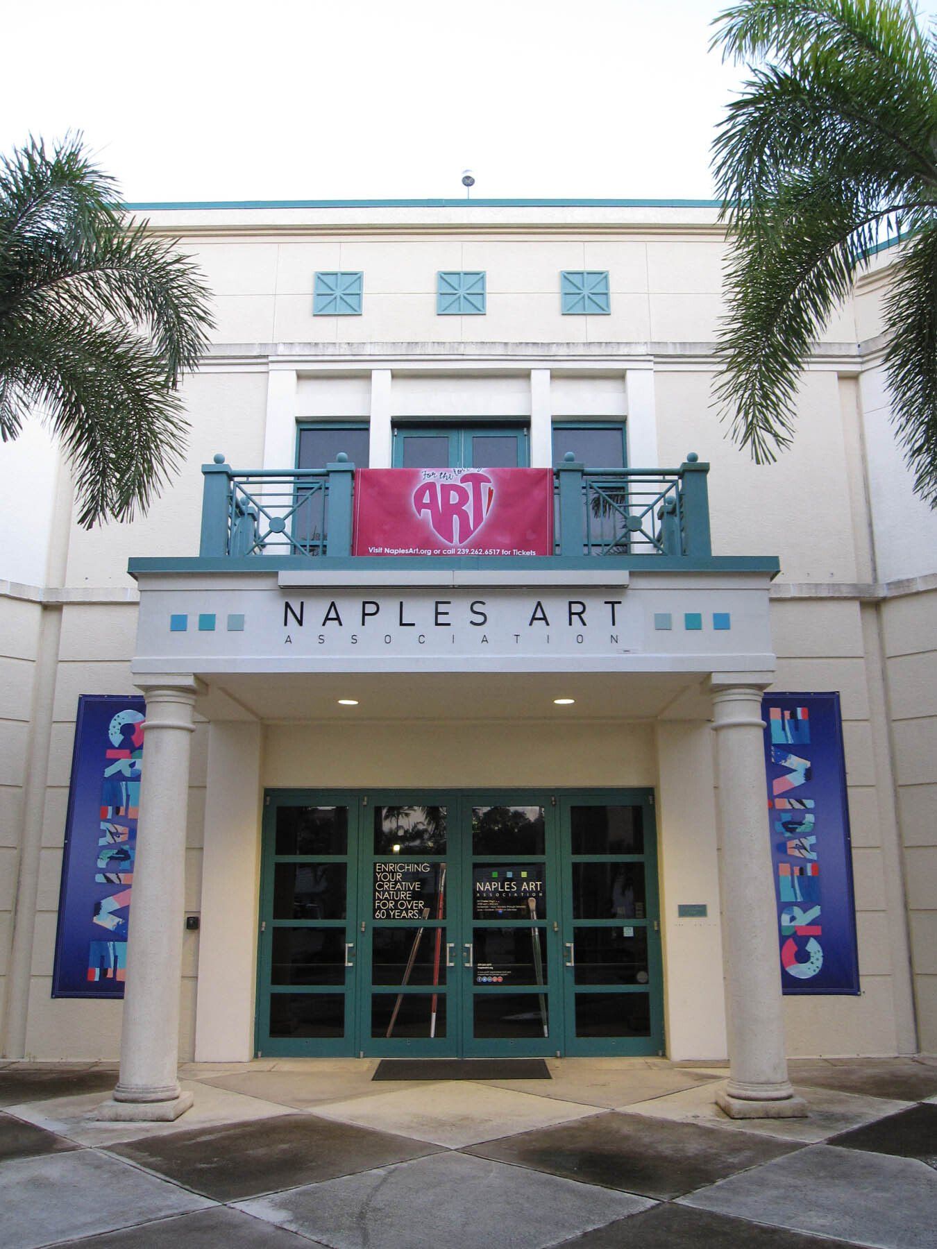 The front of a building that says naples art