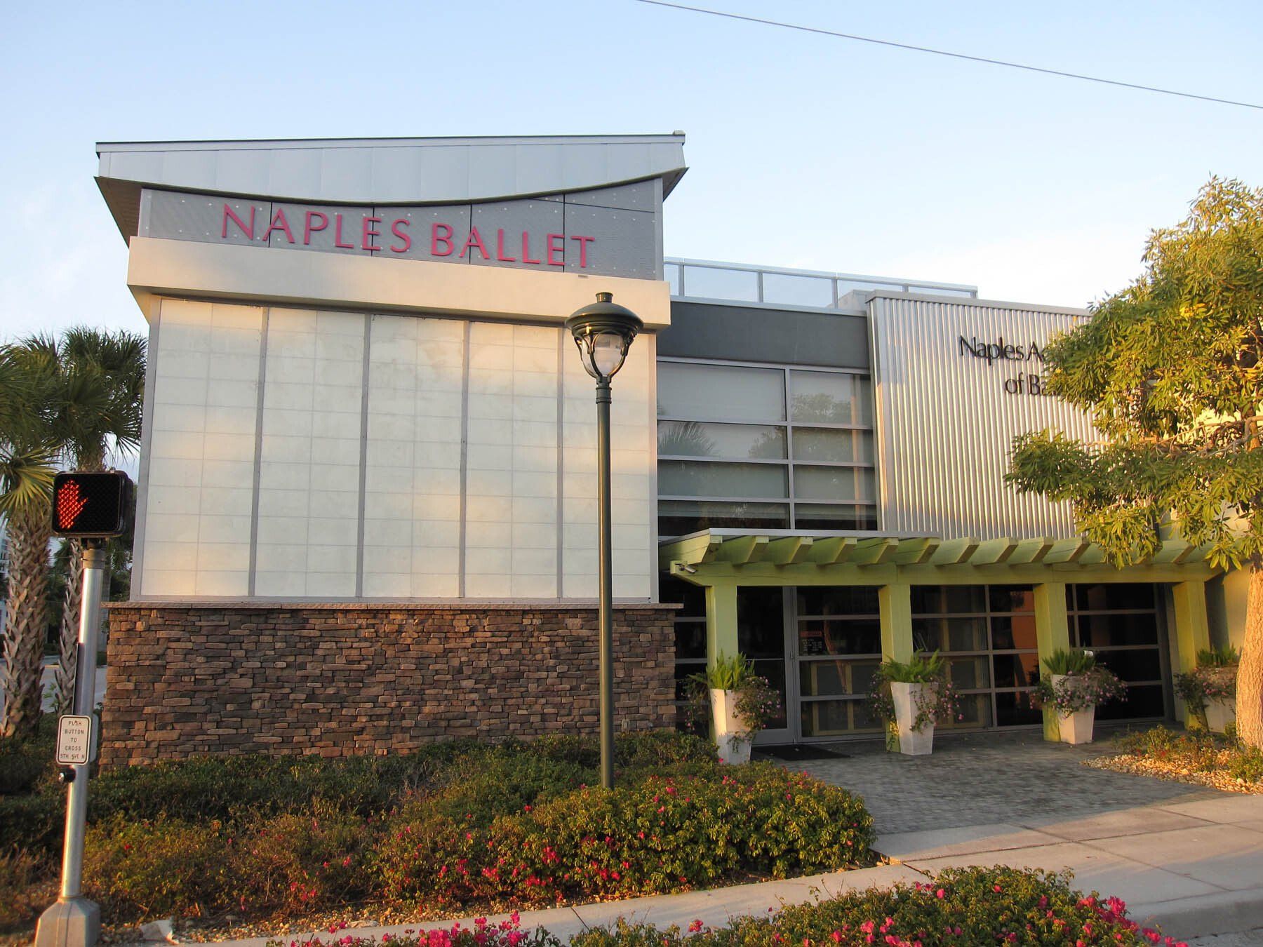 A large white building with naples ballet written on it