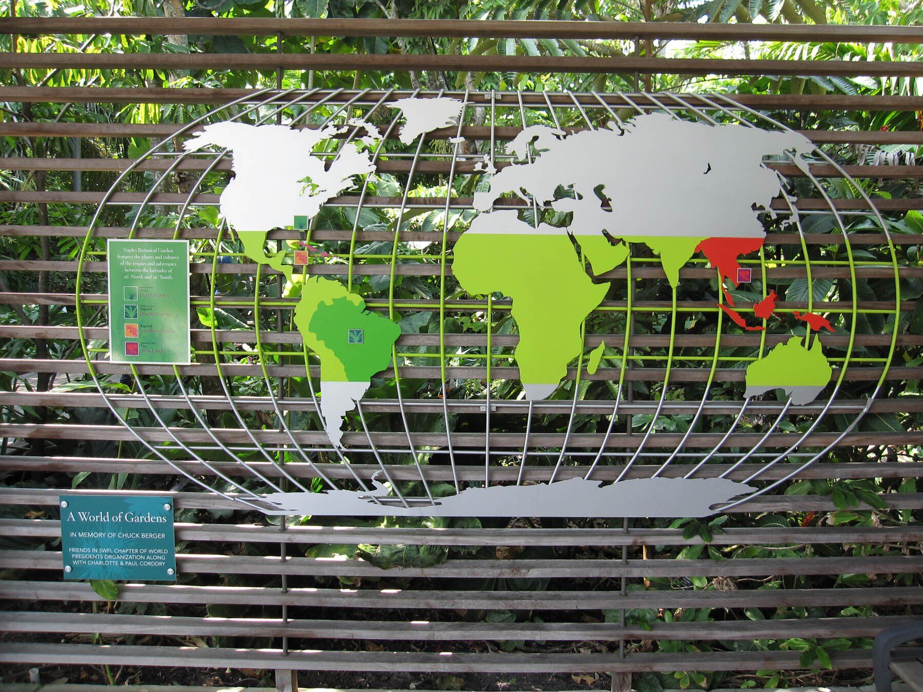 A map of the world is displayed on a wooden fence