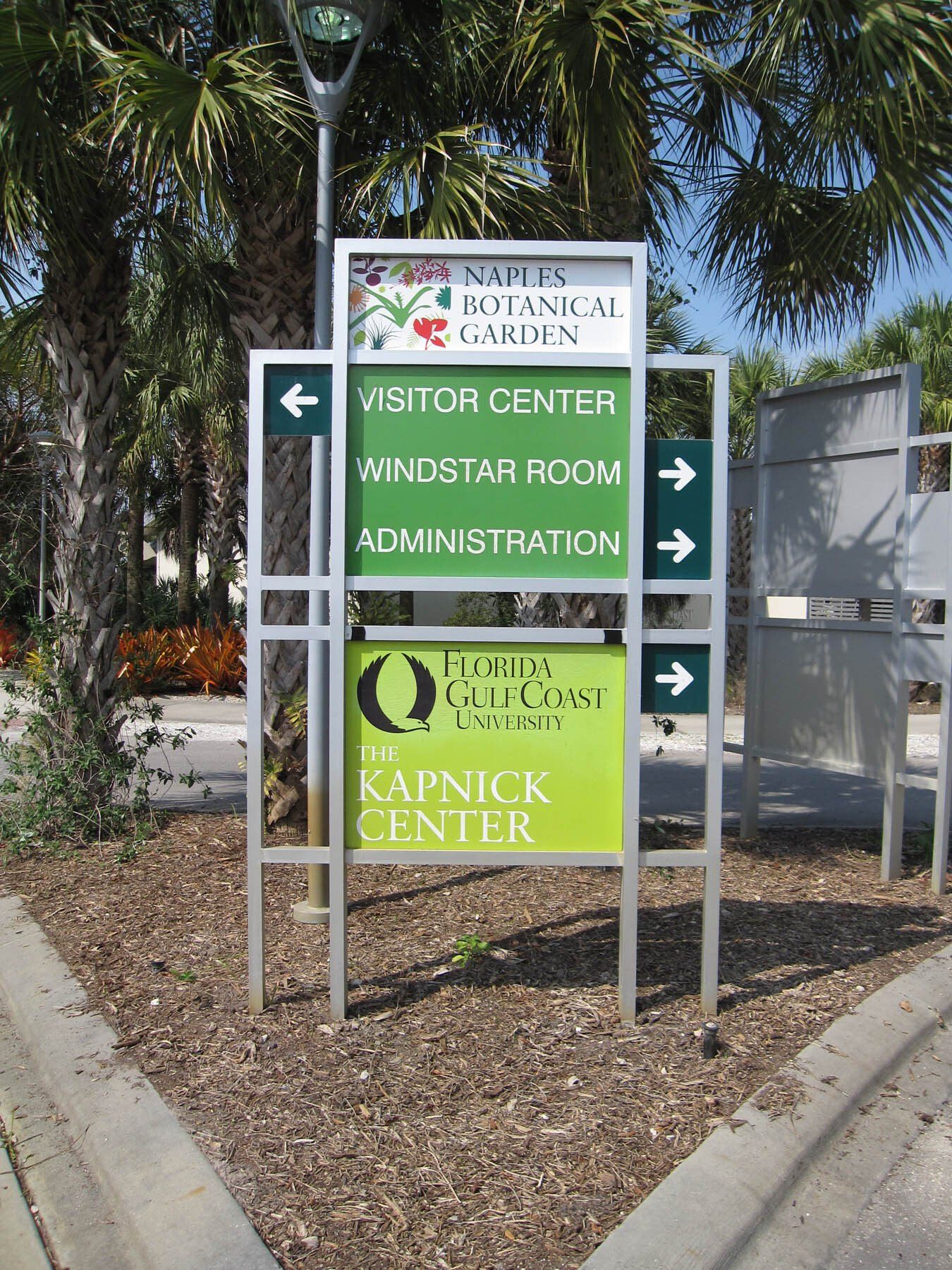 A sign for the kapnick center is sitting on the side of the road.