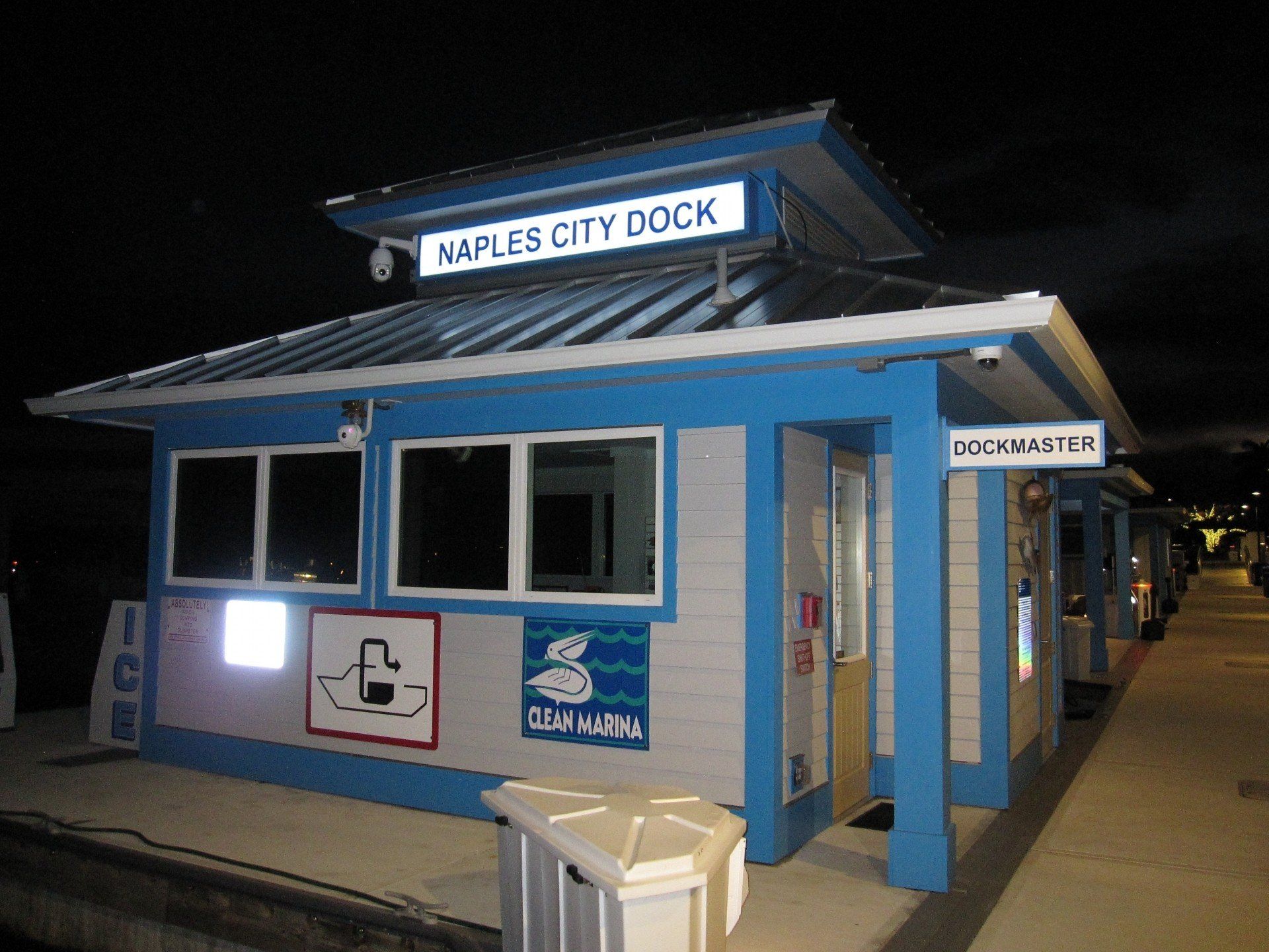 A blue and white building with a sign that says naples city dock