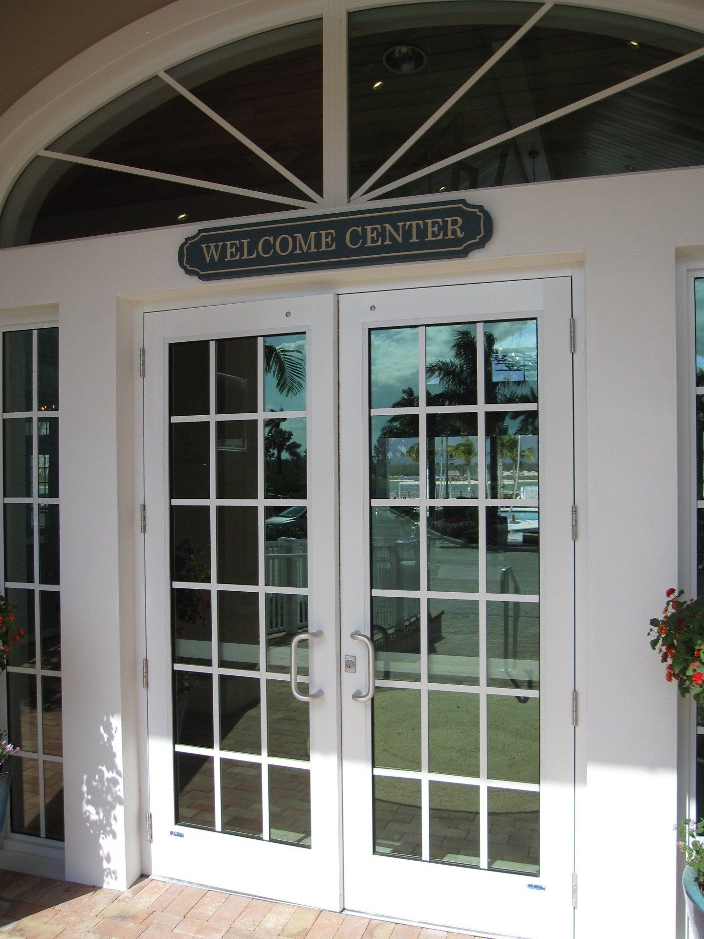 A white door with a welcome center sign above it