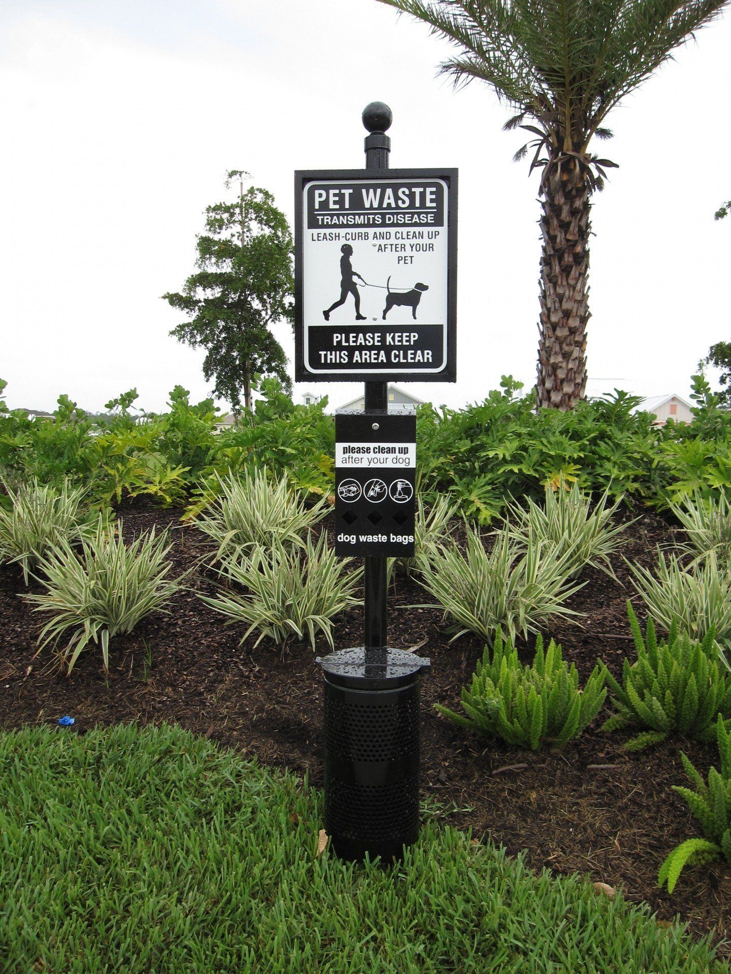 A black and white sign that says pet waste on it