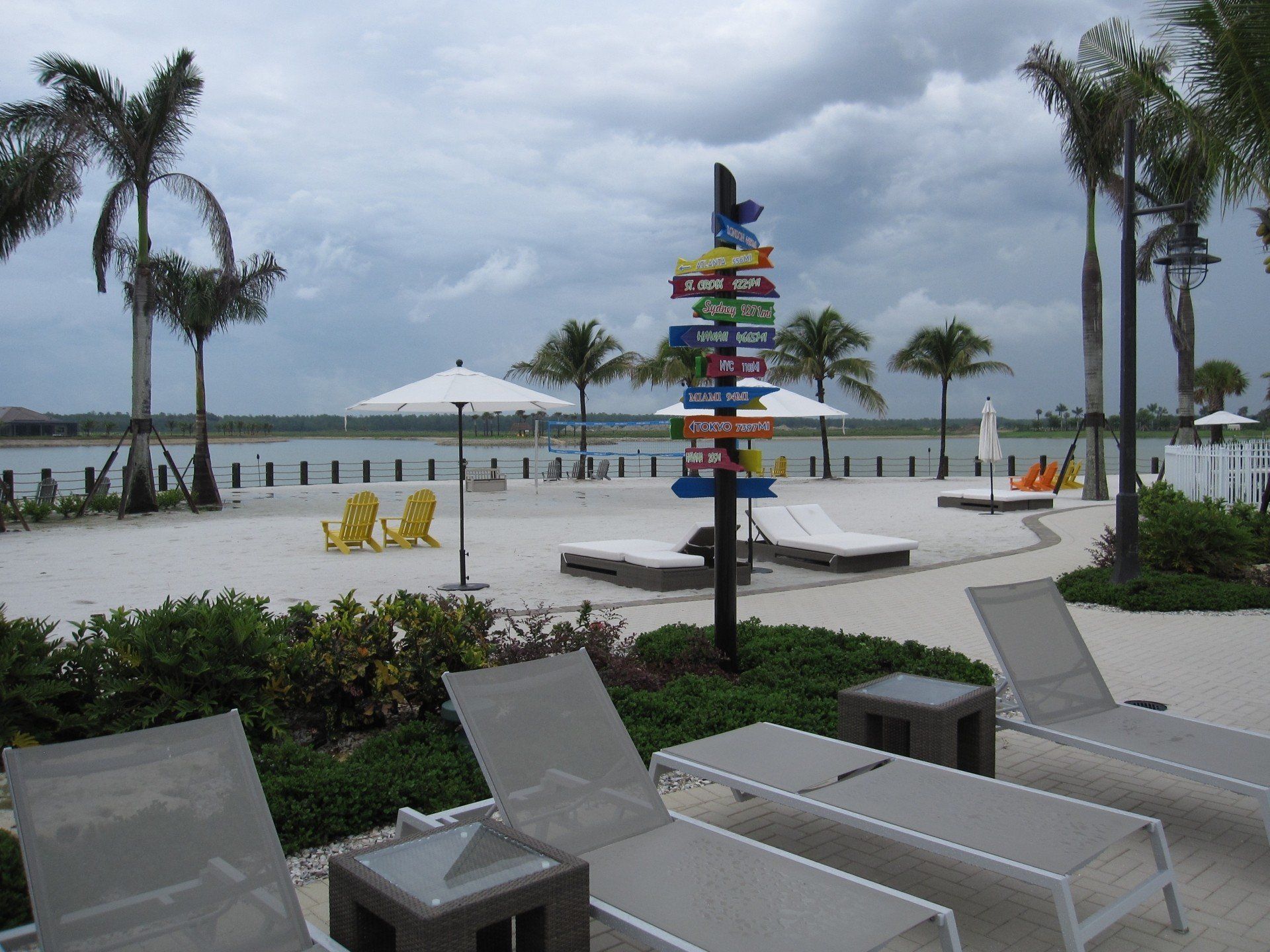 A beach with lots of chairs and umbrellas
