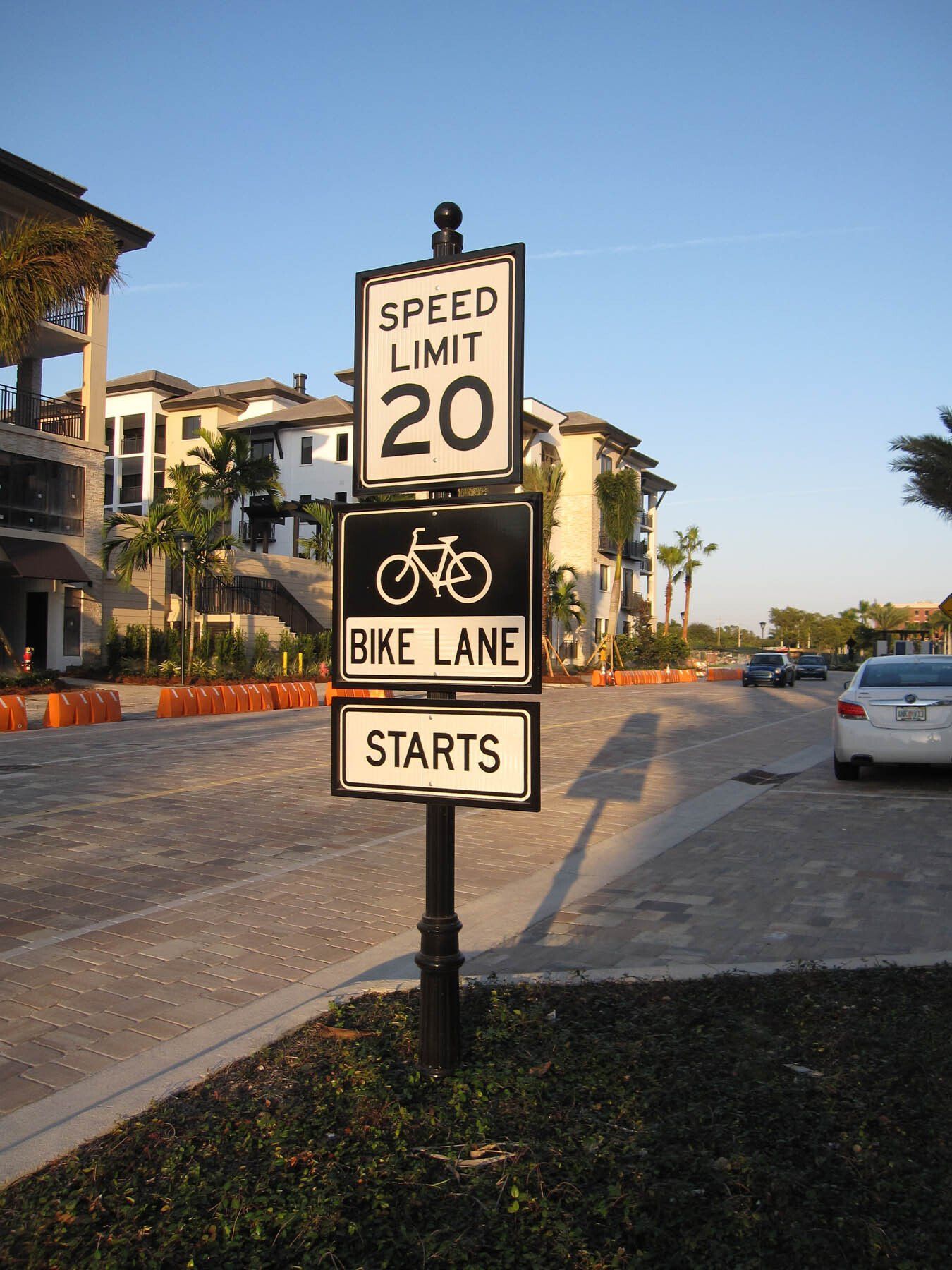 A sign that says speed limit 20 and bike lane starts