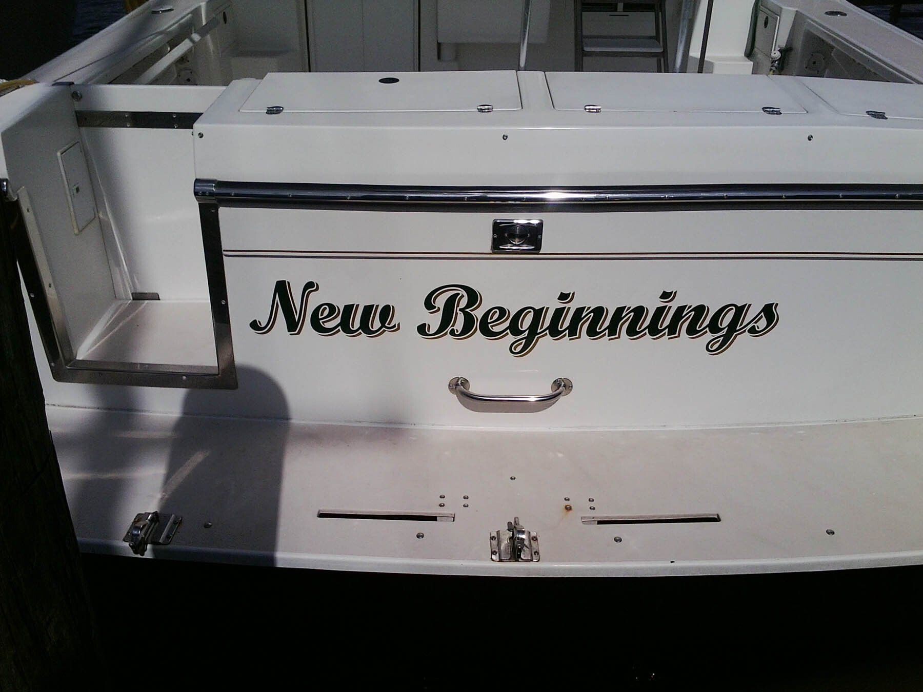 A white boat with the words new beginnings written on it