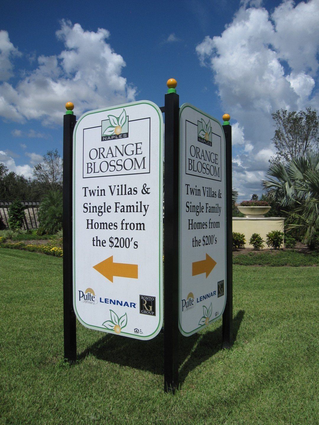 A sign for orange blossom twin villas and single family homes